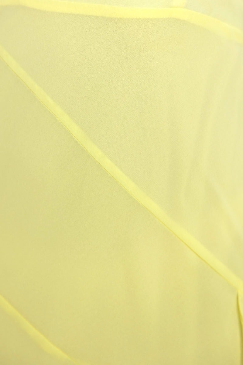 Close-up of soft yellow fabric with delicate texture, showcasing the material of the Cinzia maxi dress.