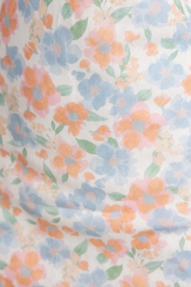 Floral print fabric featuring blue and peach flowers on a soft white background, perfect for the Kellana Midi Dress.
