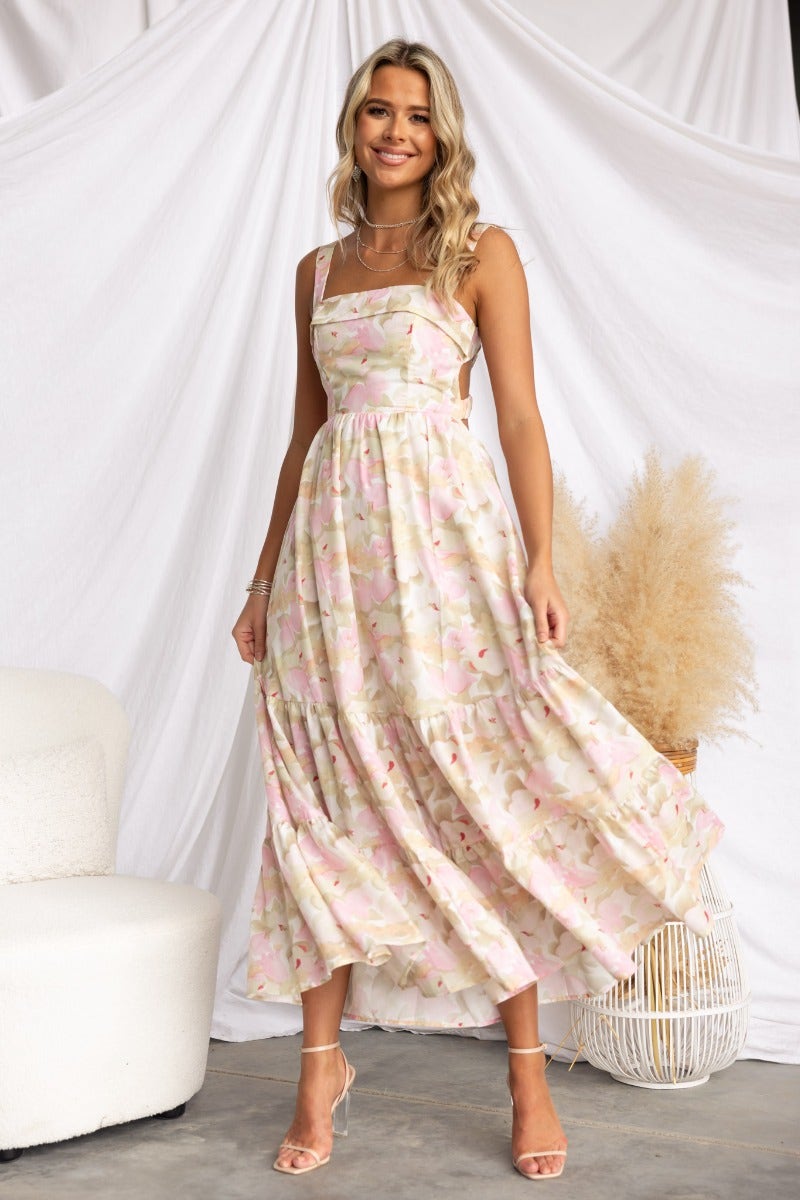 Light Hearted Maxi Dress featuring floral print, side boning, elastic back, and a flowy silhouette on a model.