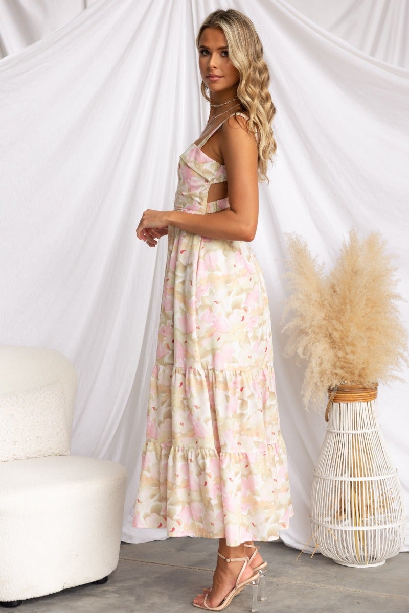 Light Hearted Maxi Dress with floral print, featuring boning at bust and elastic back, styled in a softly lit indoor setting.