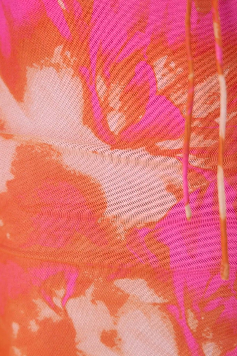 Close-up of vibrant floral print in pink and orange on the Bamba Midi Dress fabric.