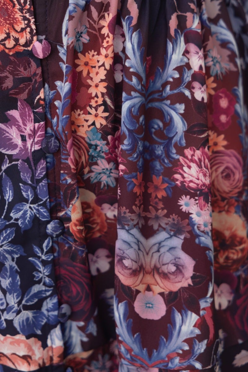 Close-up of floral print fabric on Jules Dress with gem embellishments and button details.