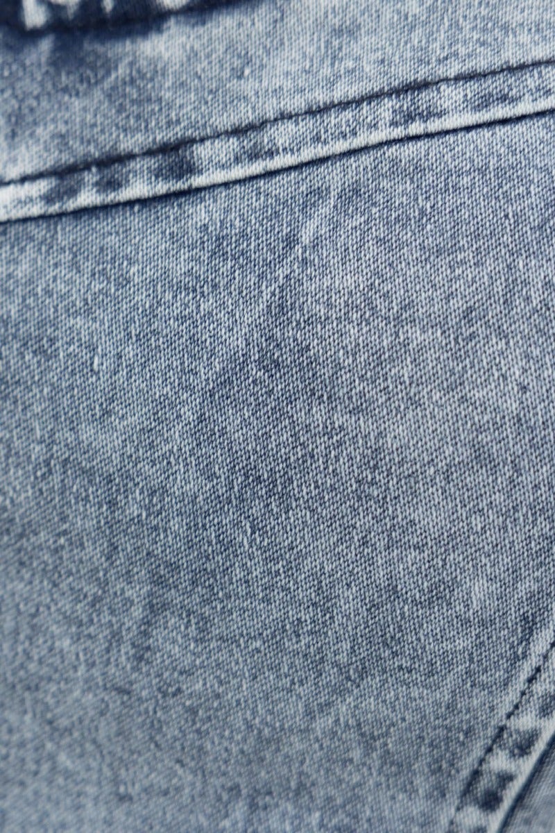 Close-up of light blue denim fabric texture showcasing the softness and stretch for the Garner Denim Playsuit.