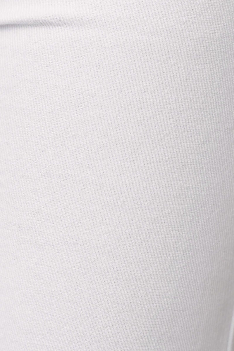 Close-up of white denim fabric with textured weave, showcasing softness and stretch for comfortable wear.