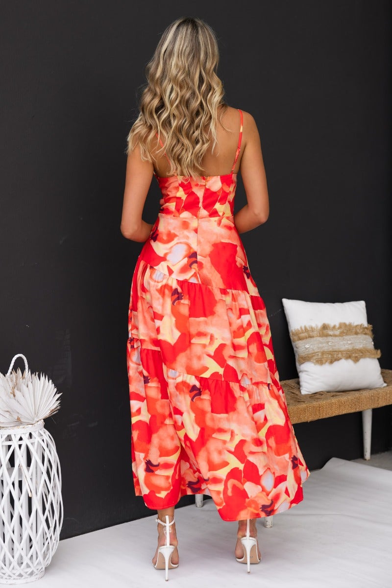 Back view of a floral print Scorpio maxi dress with adjustable straps and tiered design.