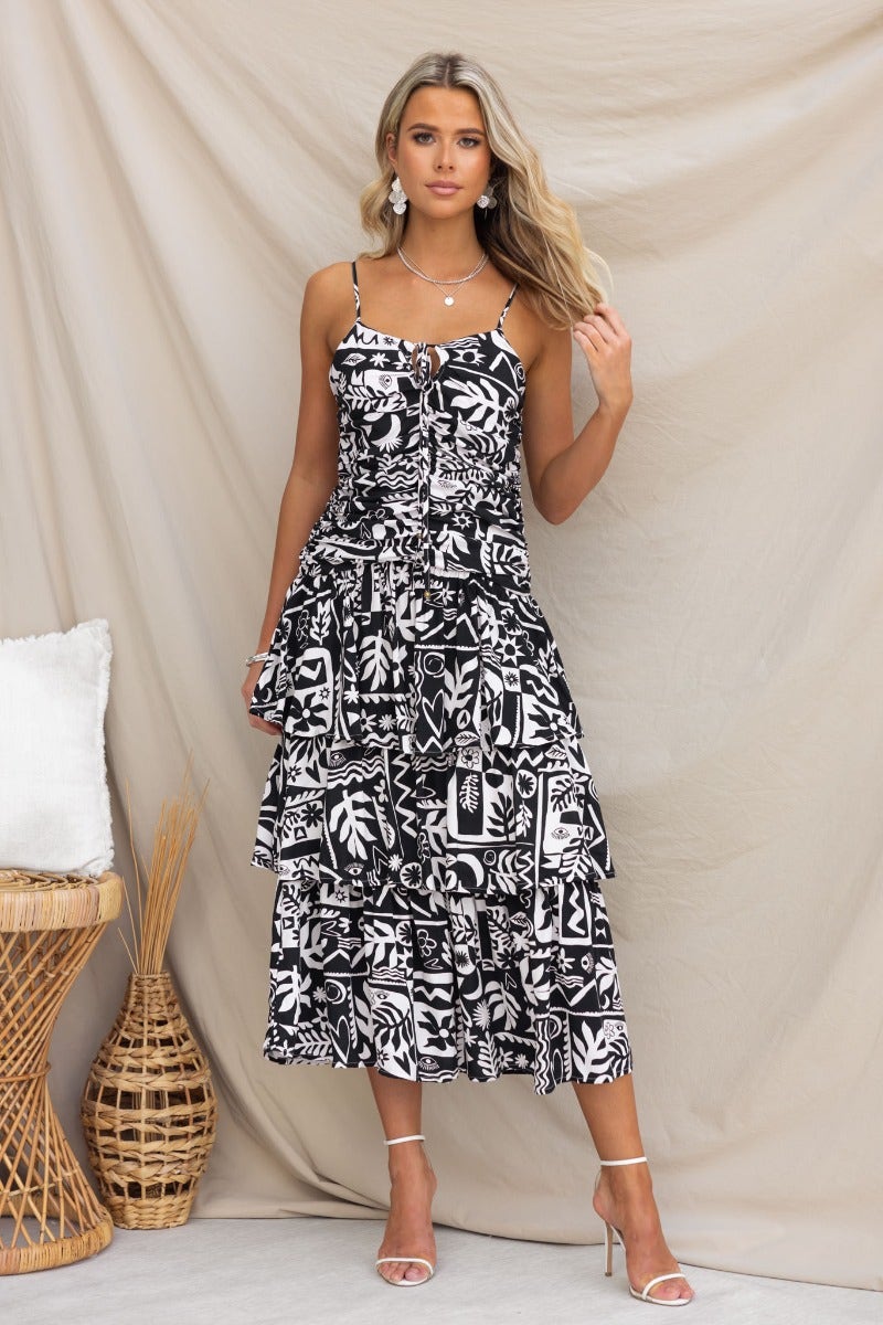 Black and white printed Rynn Midi Dress with adjustable straps and multi-tier ruffle skirt, perfect for summer.