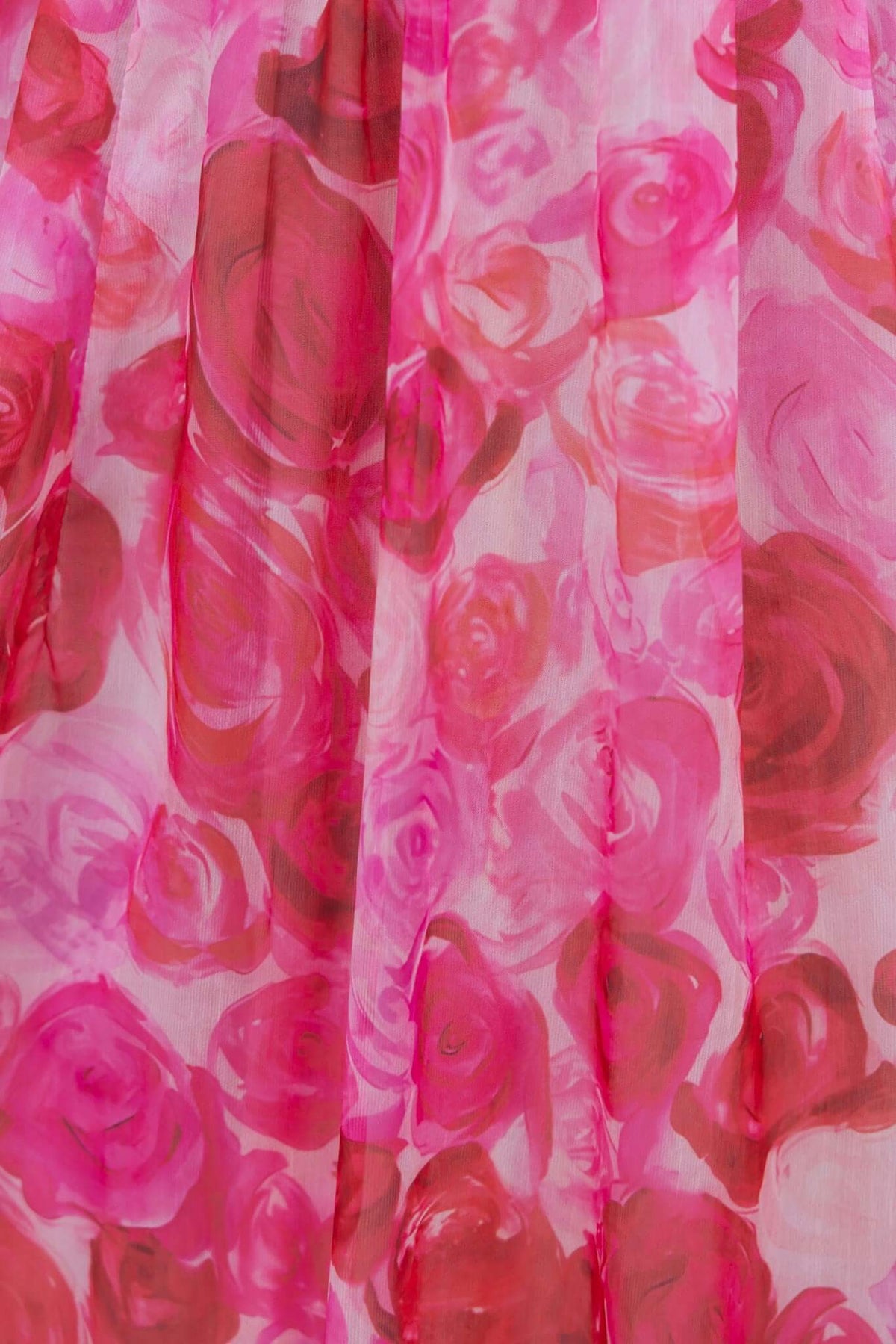Close-up of pink and red floral print on light chiffon fabric for Rosie Maxi Dress.