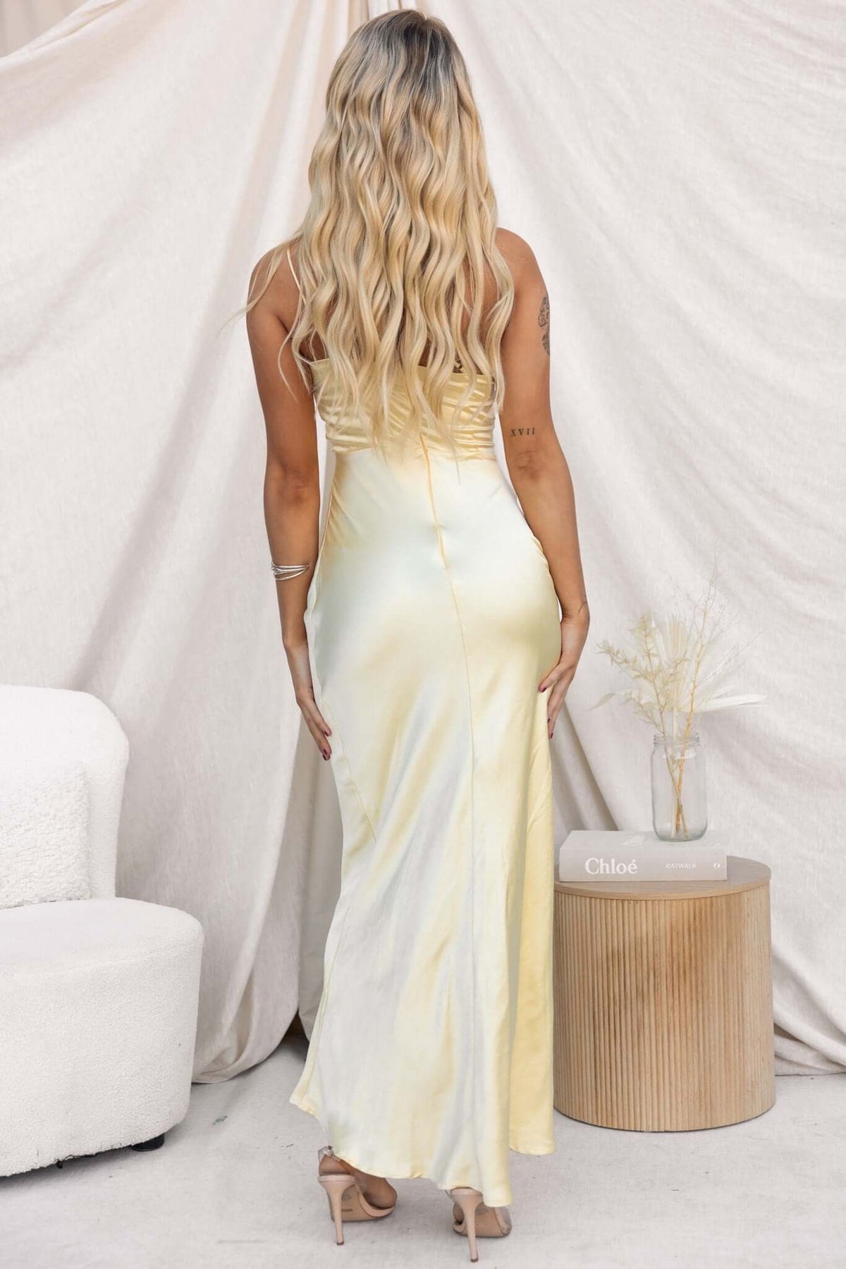 Back view of a woman in an Ainaz Maxi Dress, showcasing the satin look and adjustable straps.