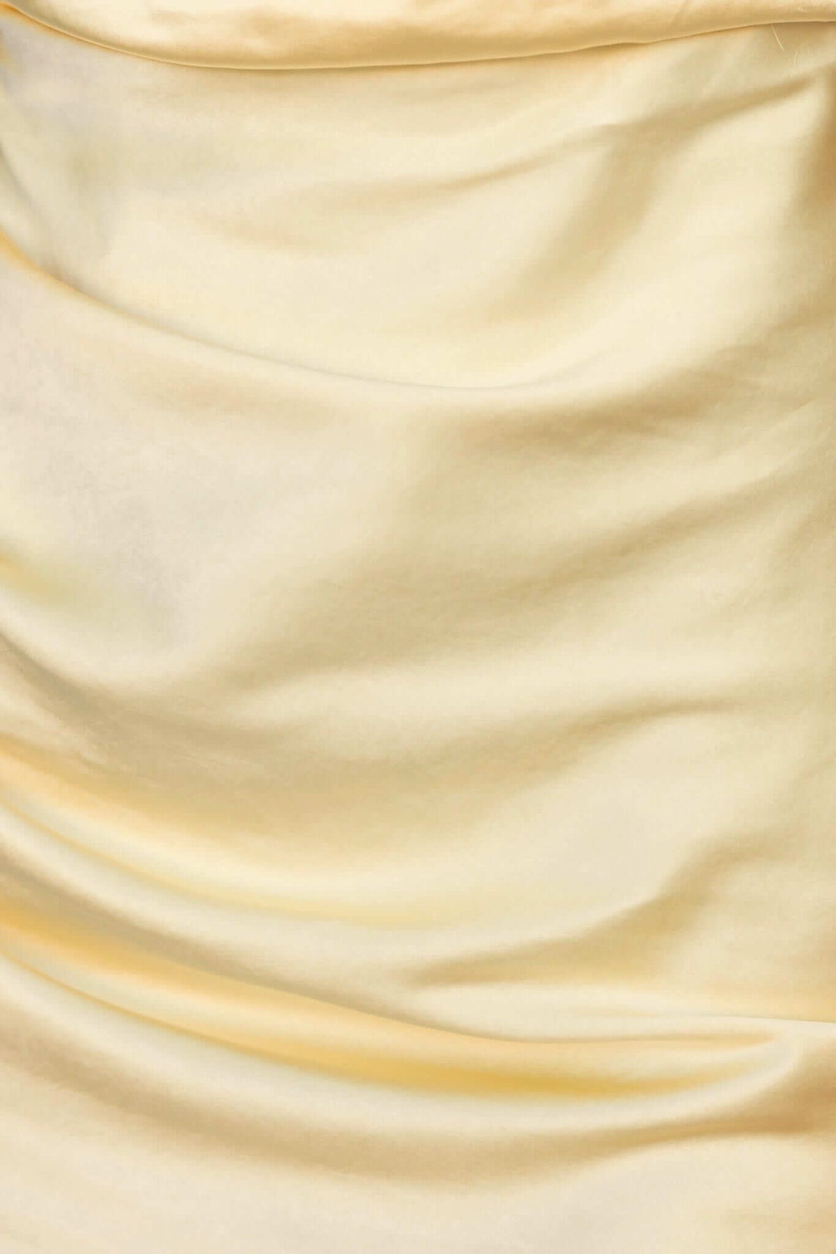 Close-up of soft, satin yellow fabric of the Ainaz Maxi Dress, showcasing the elegant drape and sheen.