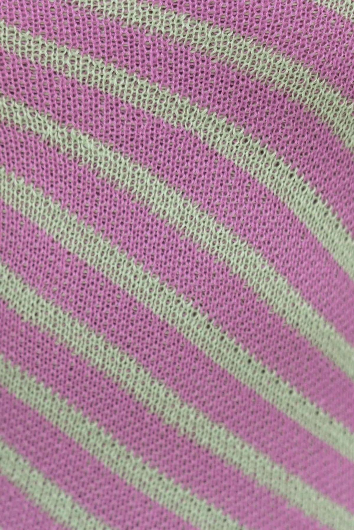 Close-up of pink and green striped knit fabric, showcasing soft texture and vibrant colors, perfect for making stylish garments.