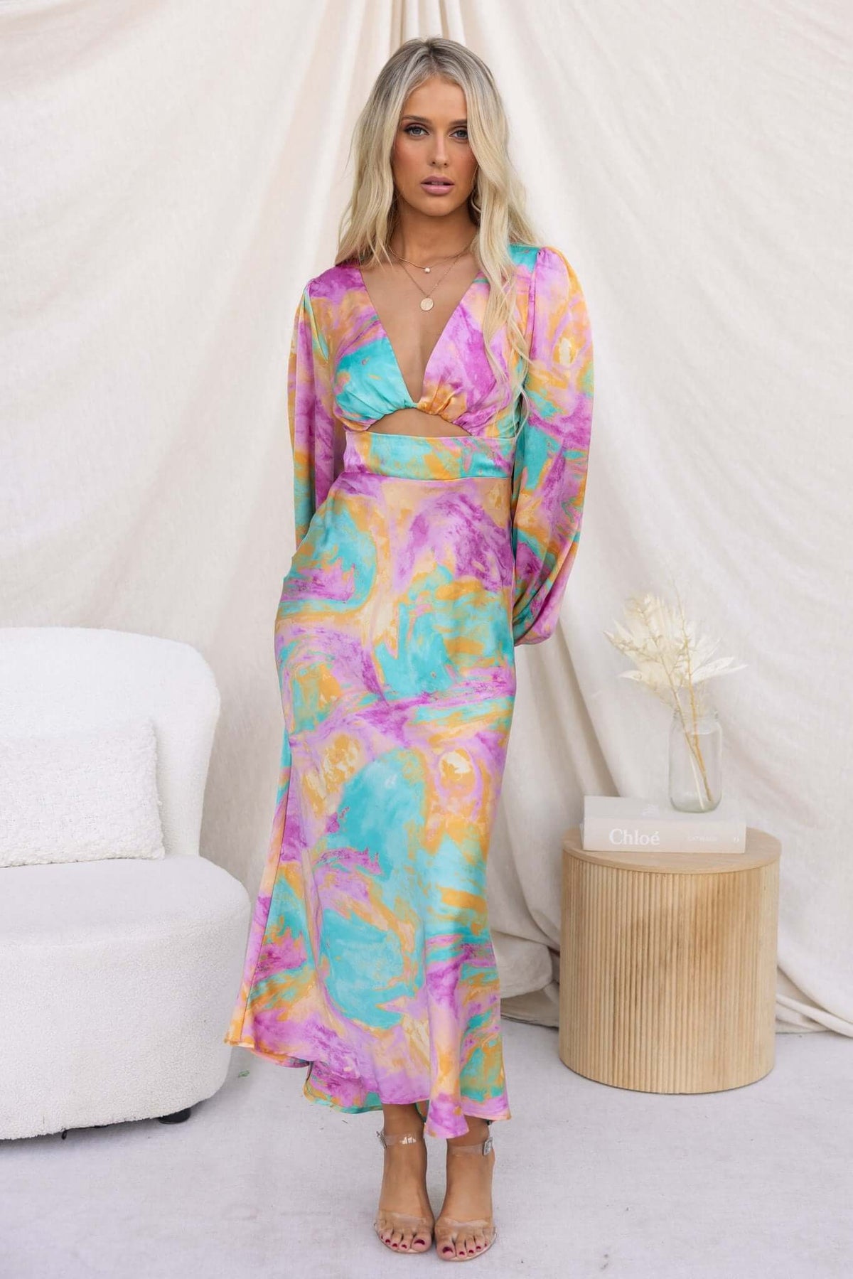 With You Maxi Dress featuring V-neckline and cut-out waist in vibrant pastel colors, styled with chic accessories.