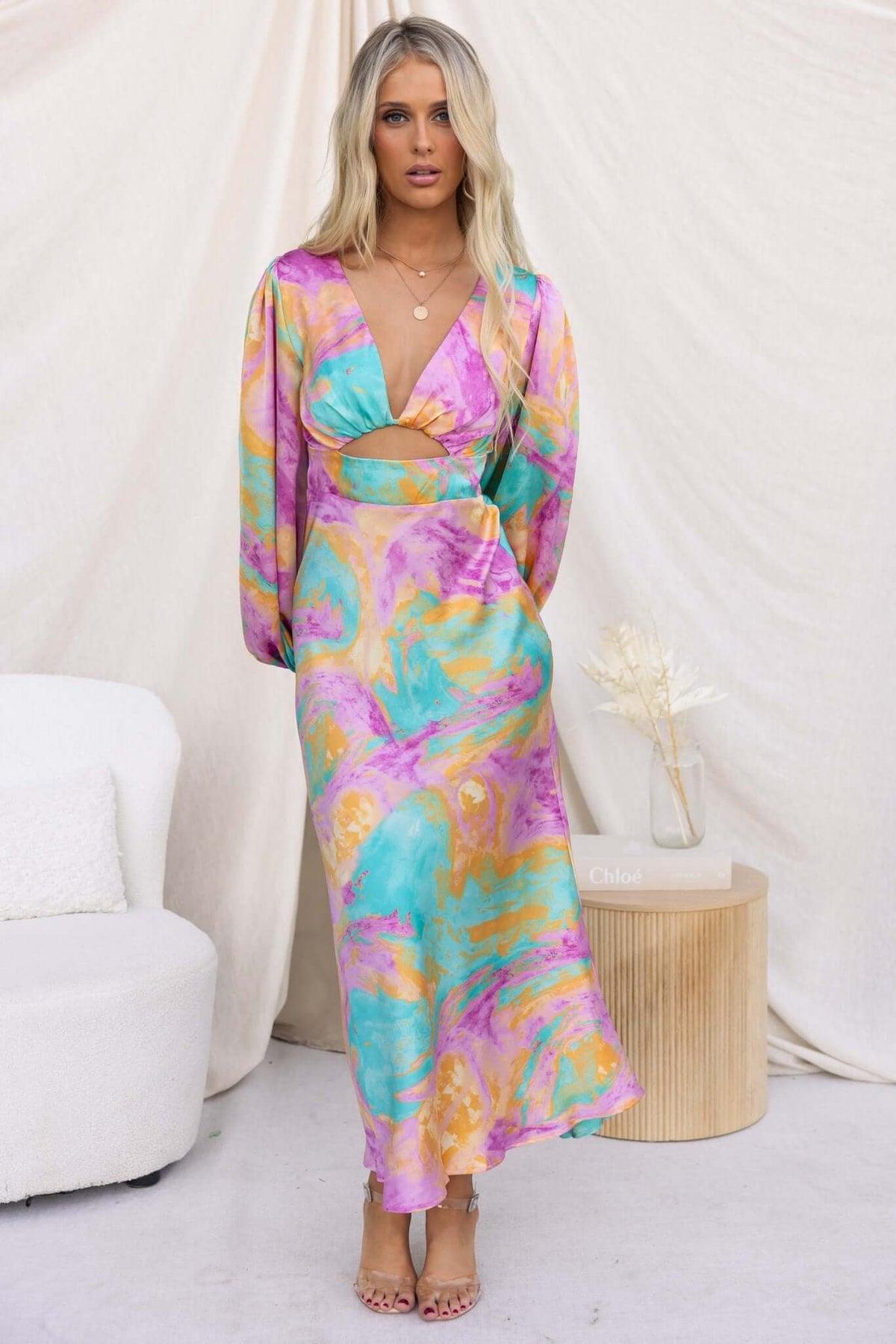 Model wearing the With You Maxi Dress featuring a V-neckline, cut-out waist, and vibrant multicolor satin fabric.