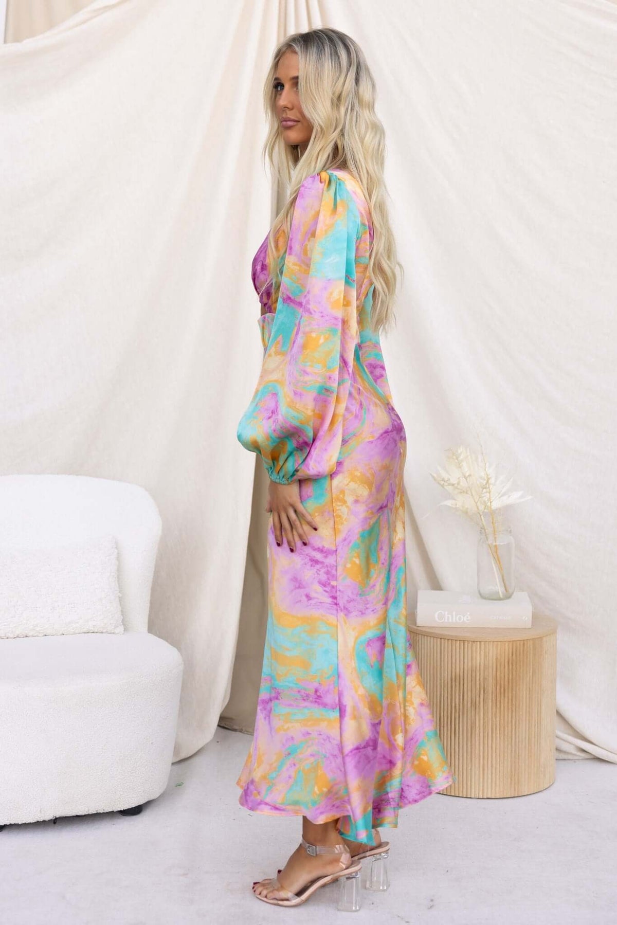 Model wearing the With You Maxi Dress featuring a colorful print, V-neckline, and elegant flowing design.