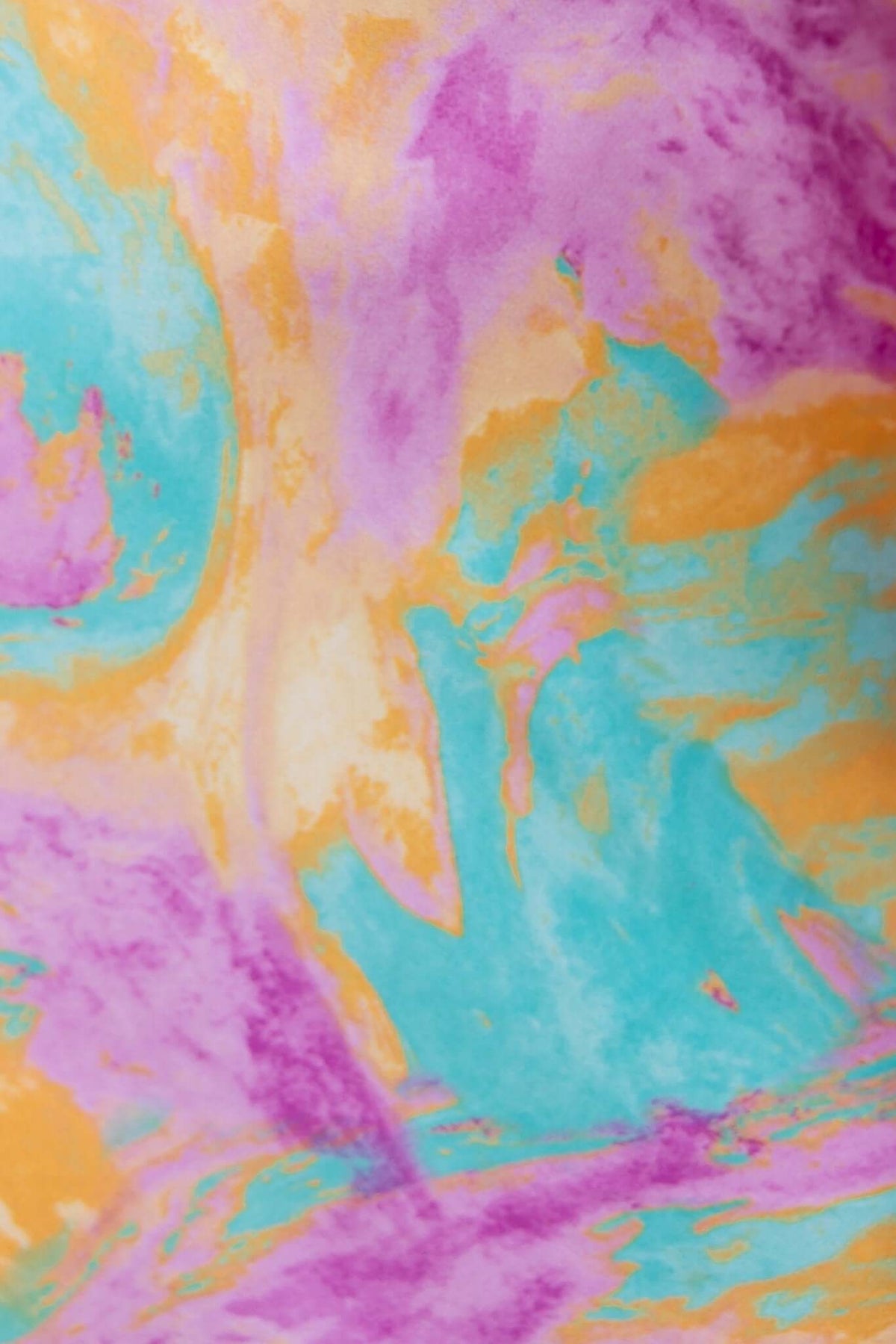Vibrant marbled fabric in pink, blue, and orange hues, perfect for stylish maxi dress designs.