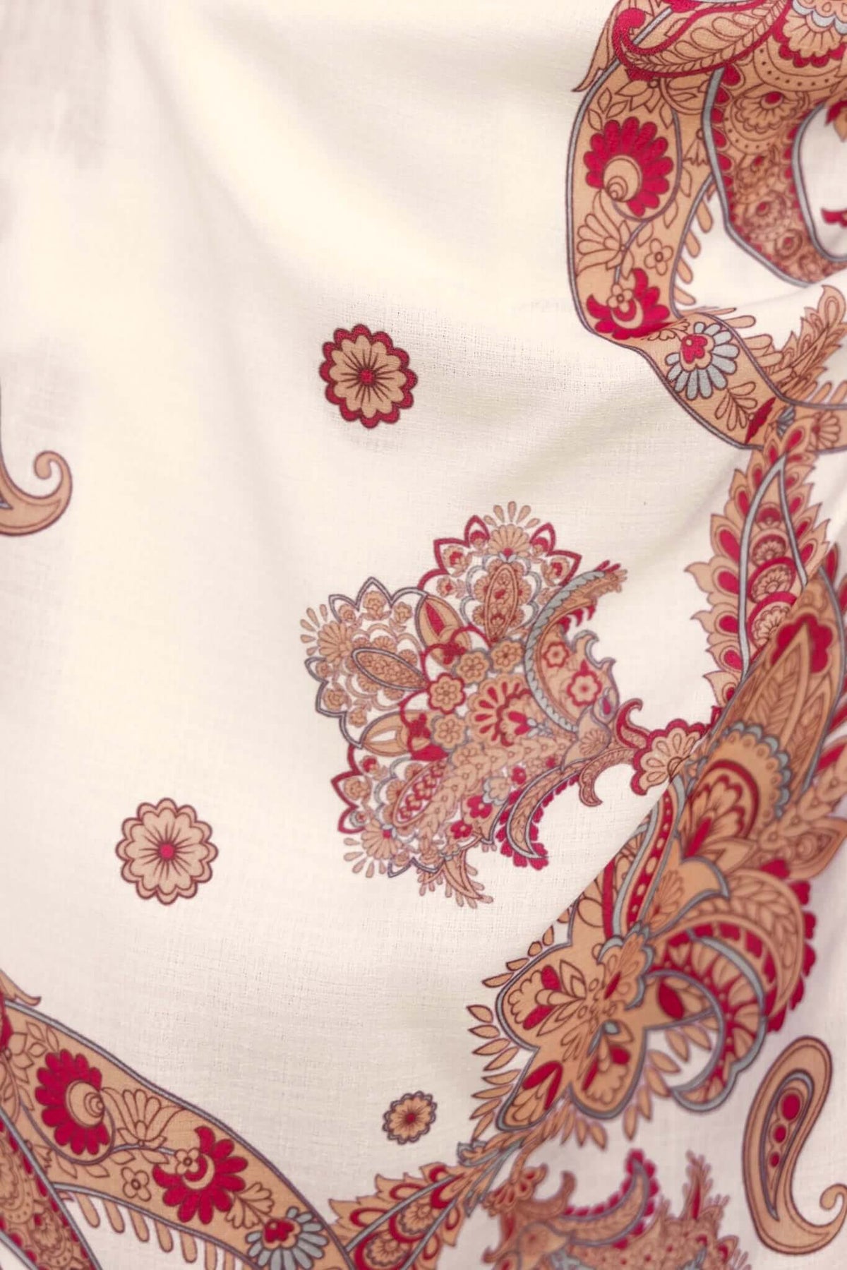 Detailed paisley pattern featuring warm colors on a light fabric, ideal for a stylish playsuit design.