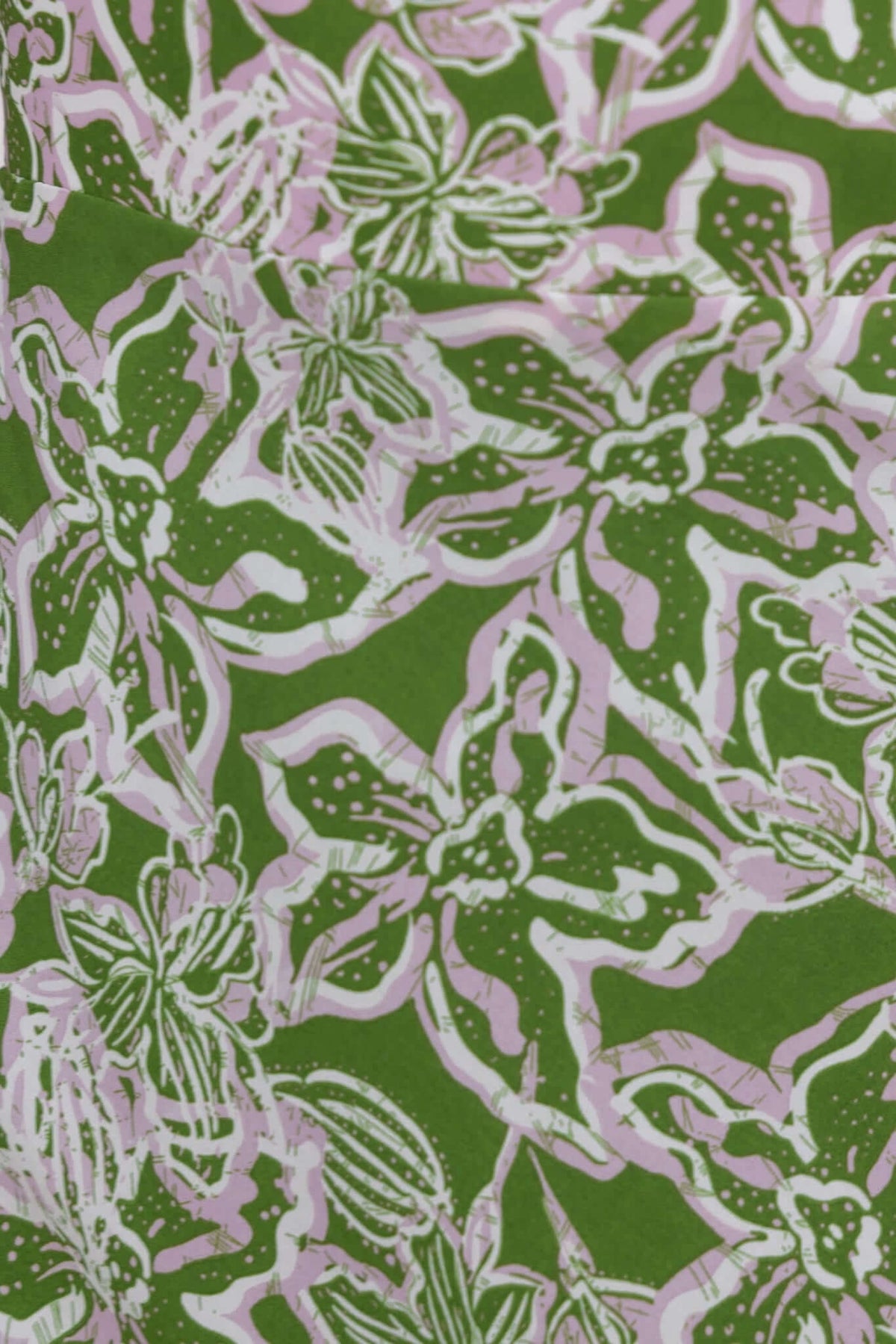 Vibrant floral pattern in pink and white over a green background, ideal for a stylish maxi dress.