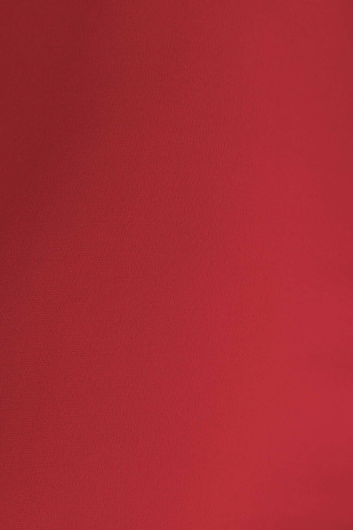 Close-up of luxurious red fabric showcasing a smooth texture, ideal for a stylish maxi dress.