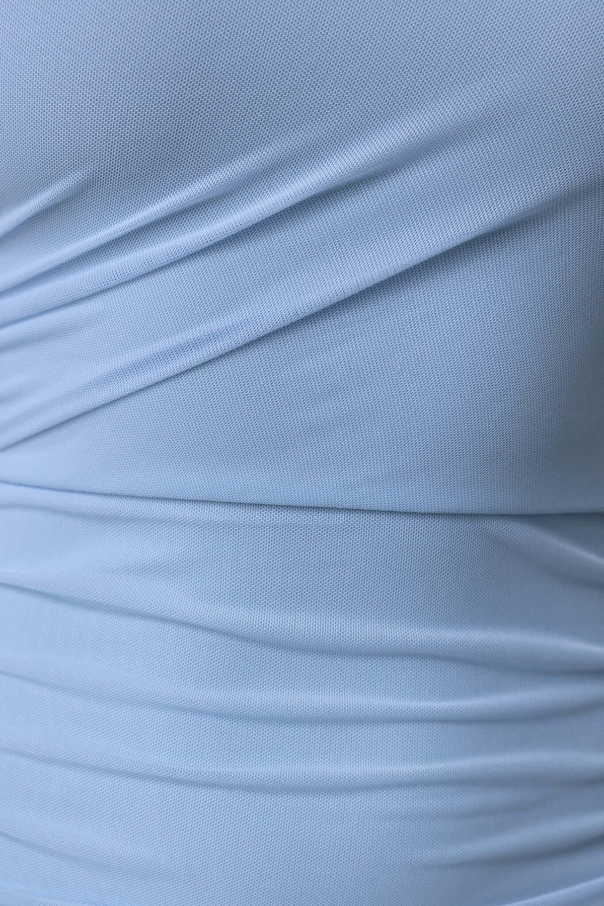 Close-up of light blue fabric showcasing ruching details, highlighting stretch material of Stolen Kiss Maxi Dress.