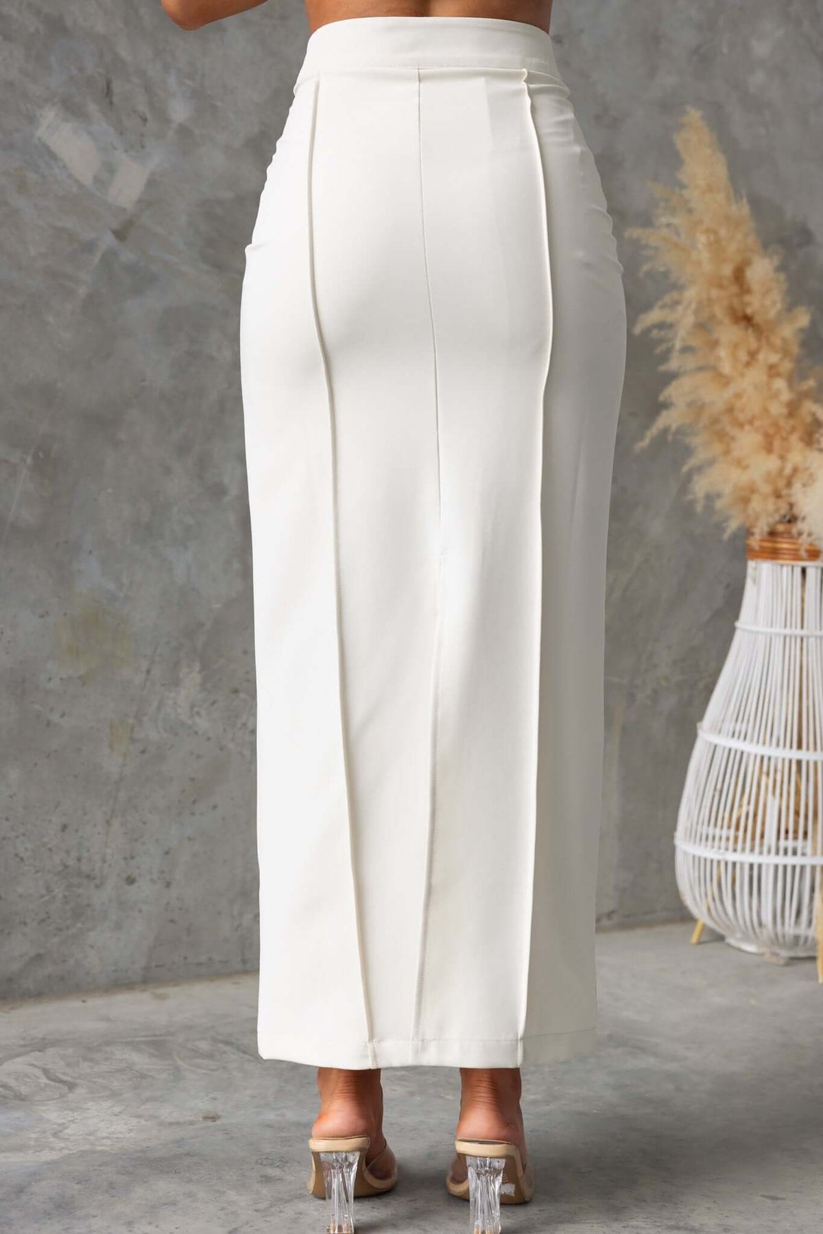Back view of Jayne Maxi Skirt showing mid-high waist and split detail, styled with a neutral backdrop.