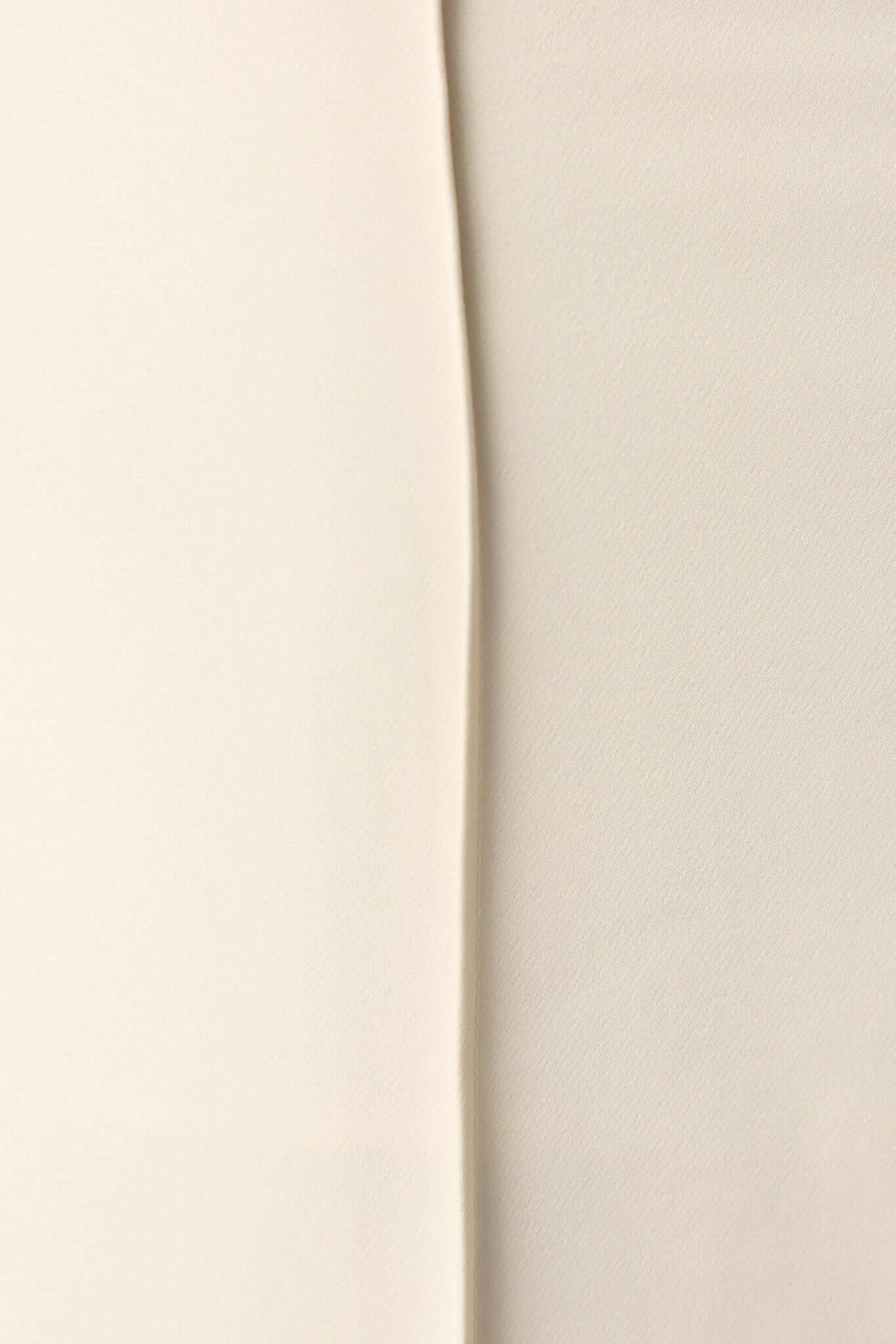 Close-up of the fabric textures of the Jayne Maxi Skirt in cream and beige colors, showcasing premium materials.