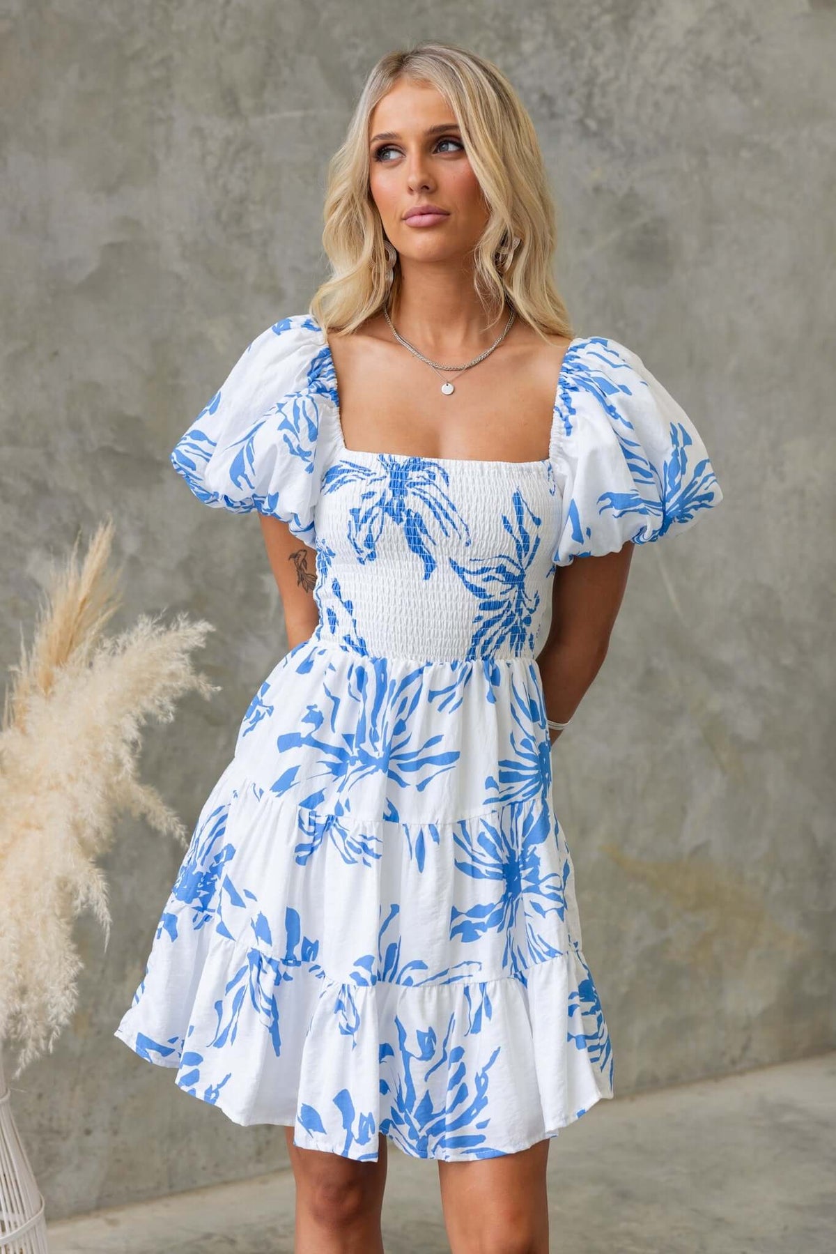 Blue Palms Dress with shirred bodice and balloon sleeves, featuring a white and blue floral design.