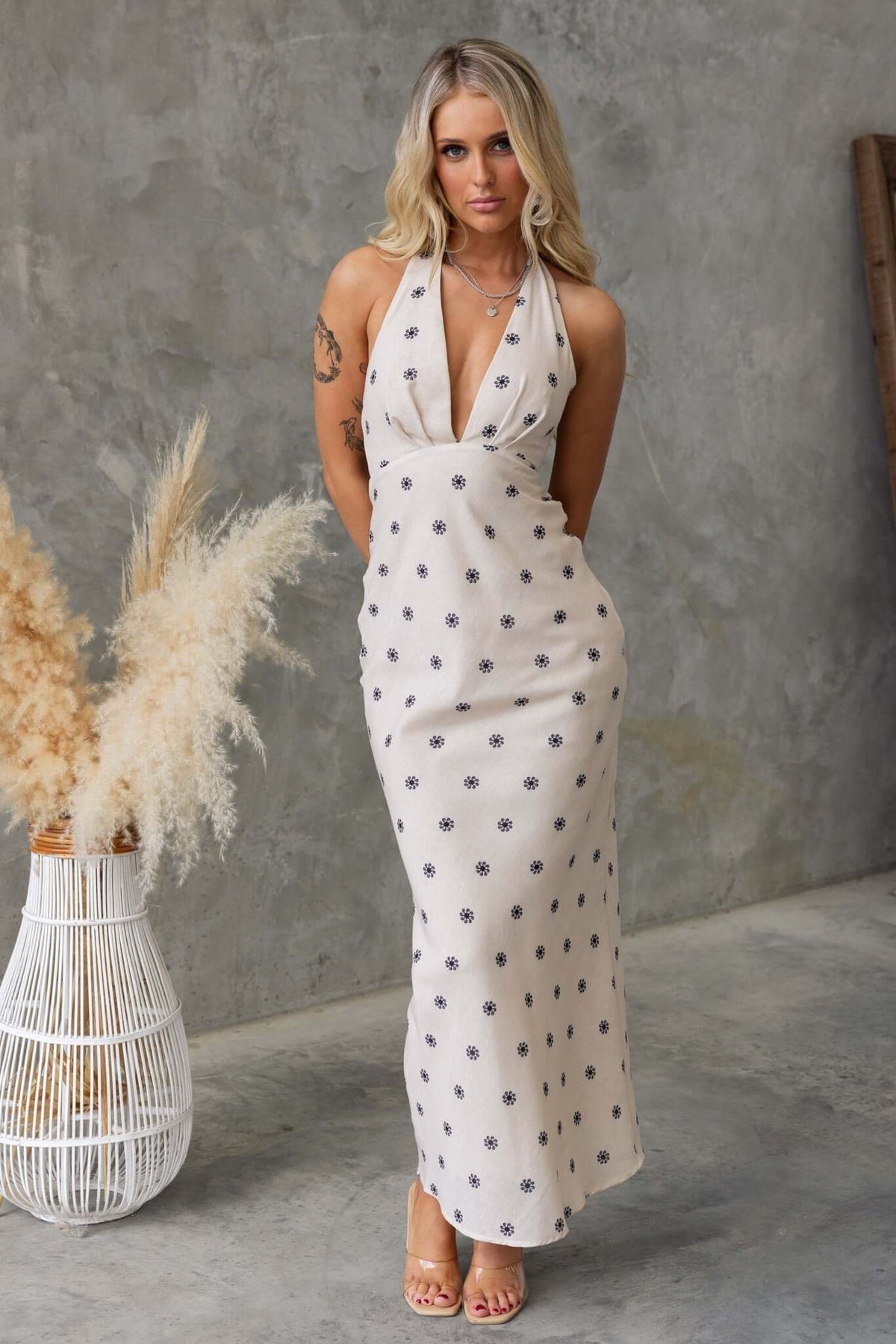 Fulton Maxi Dress featuring adjustable tie straps, a halter neck, and a sleek floral design for a stylish summer look.
