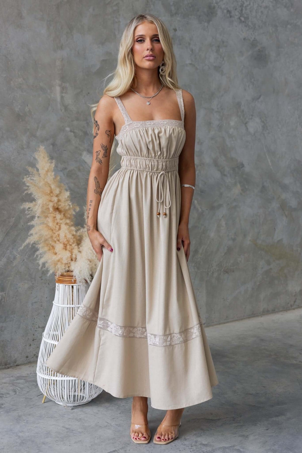 Eletti Midi Dress with lace detailing, elastic waist, and tie, creating a stylish linen look for summer occasions.