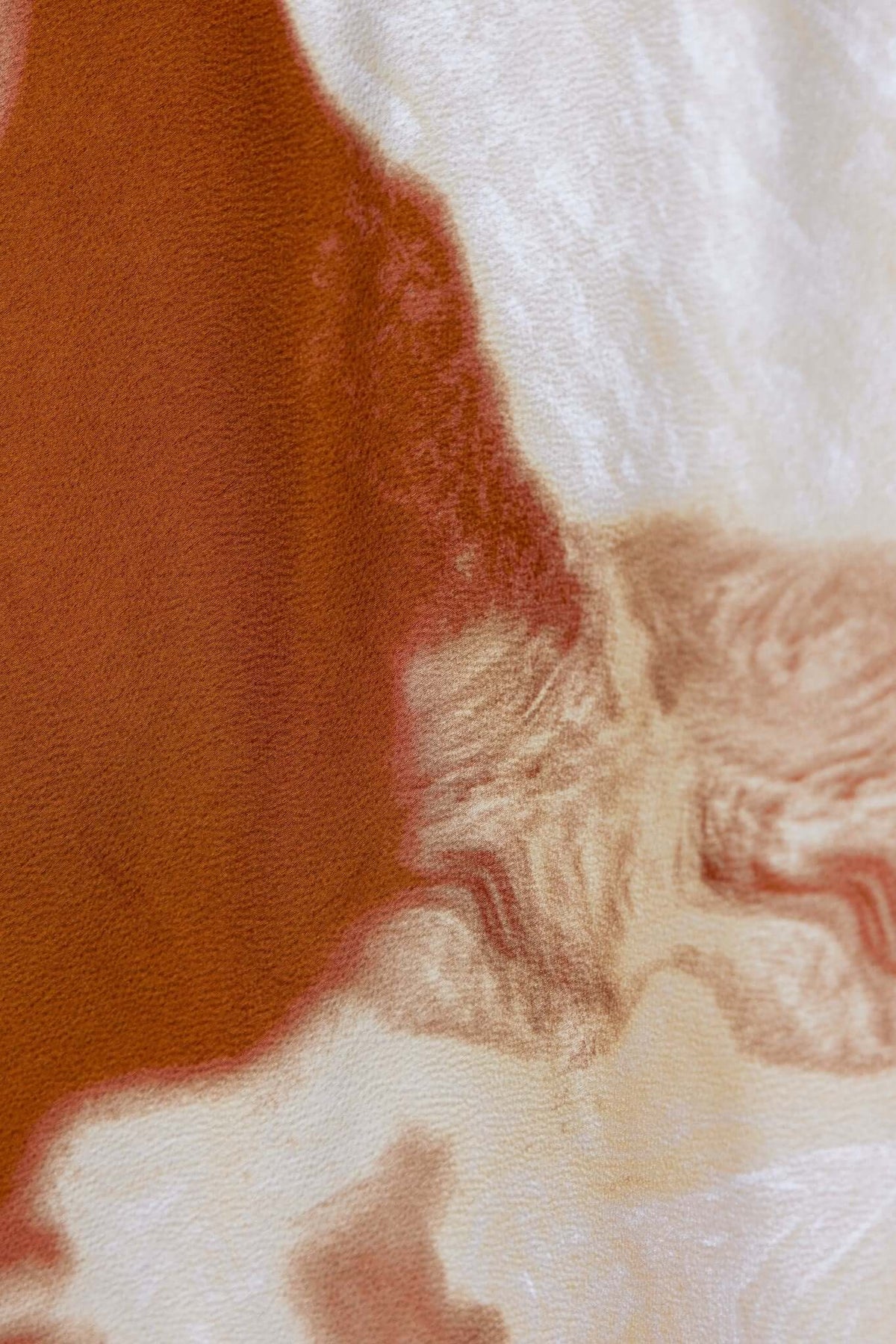 Close-up of Cooperi Midi Dress fabric, showcasing earthy tones and silky texture.