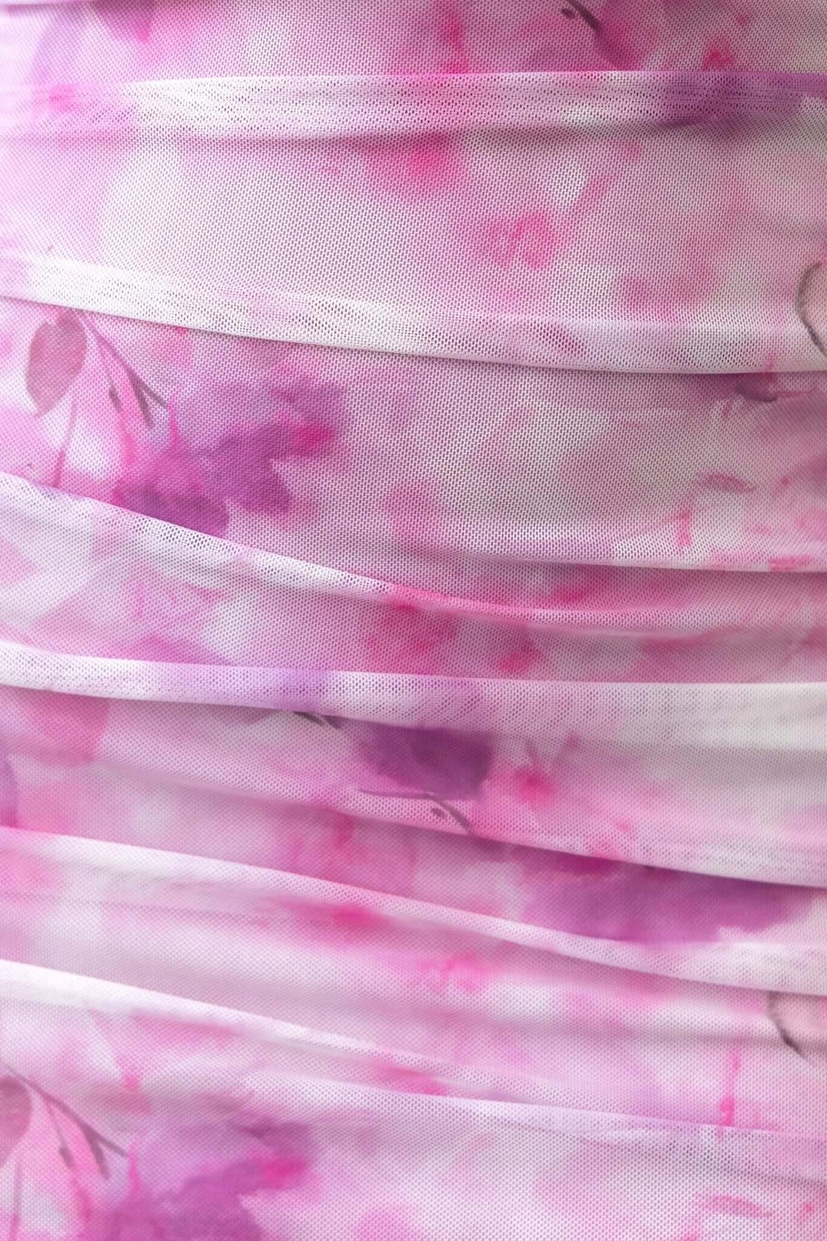 Close-up of pink floral mesh fabric showcasing ruching details for Stolen Kiss Maxi Dress.