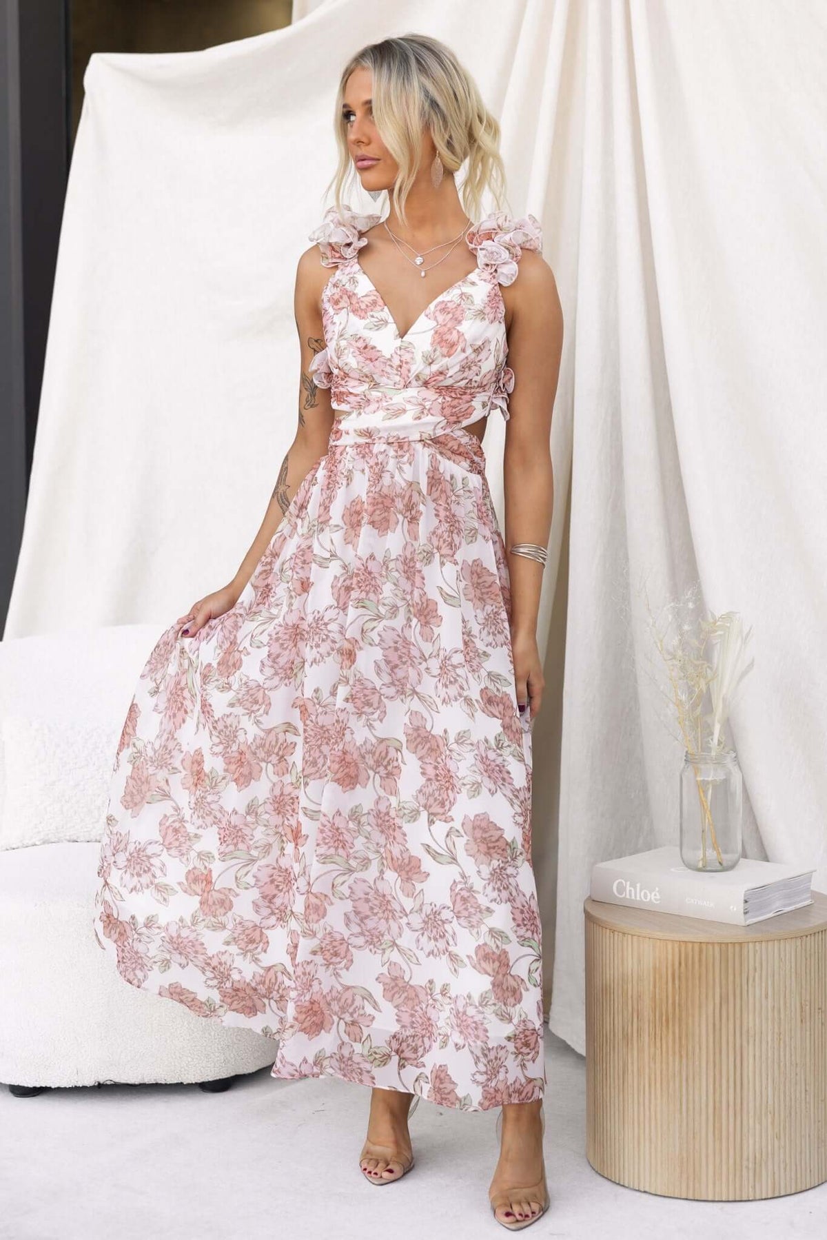 Model wearing Luciana Maxi Dress with floral print, ruffle straps, and a V-neckline, styled elegantly.