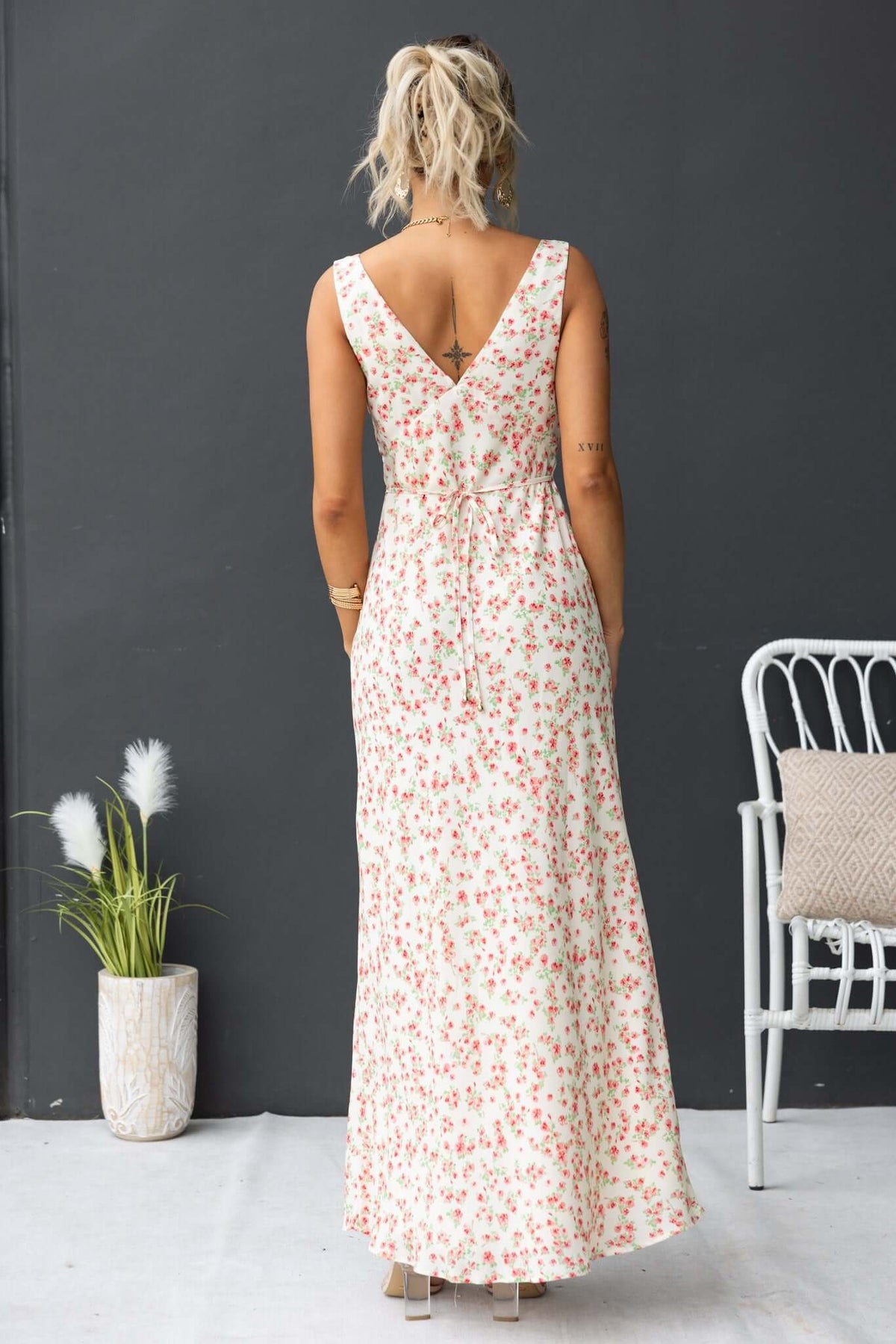 Back view of Joliet Maxi Dress featuring a floral print, V-neckline, and tie detail for a stylish summer look.