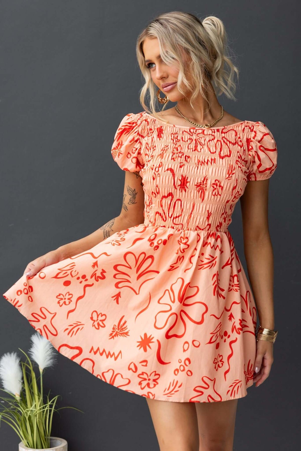Missie Dress with elastic bodice, vibrant floral patterns, and short puff sleeves, perfect for casual outings.