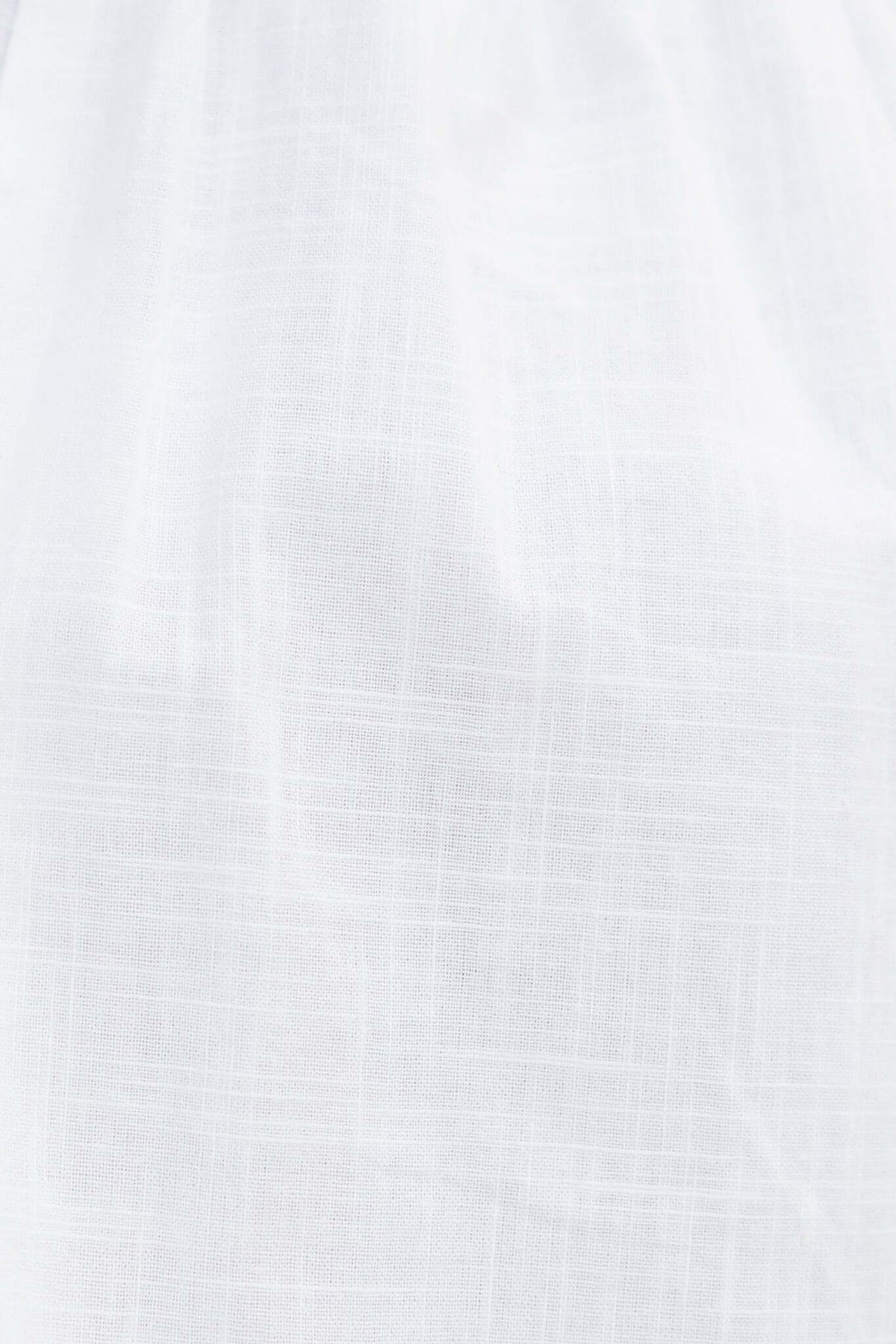 Close-up of white fabric texture, showcasing a soft, lightweight, and breathable material suitable for clothing.