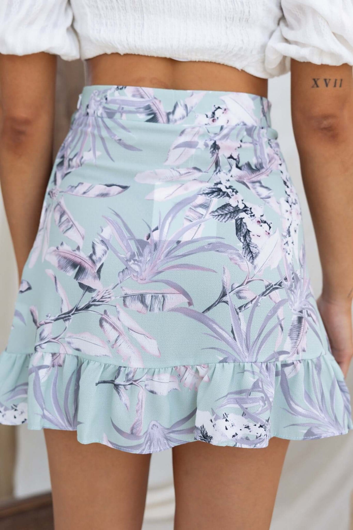 Cadern Skirt in pastel floral print, mid-high waist fit with frill hem, perfect for summer outfits.