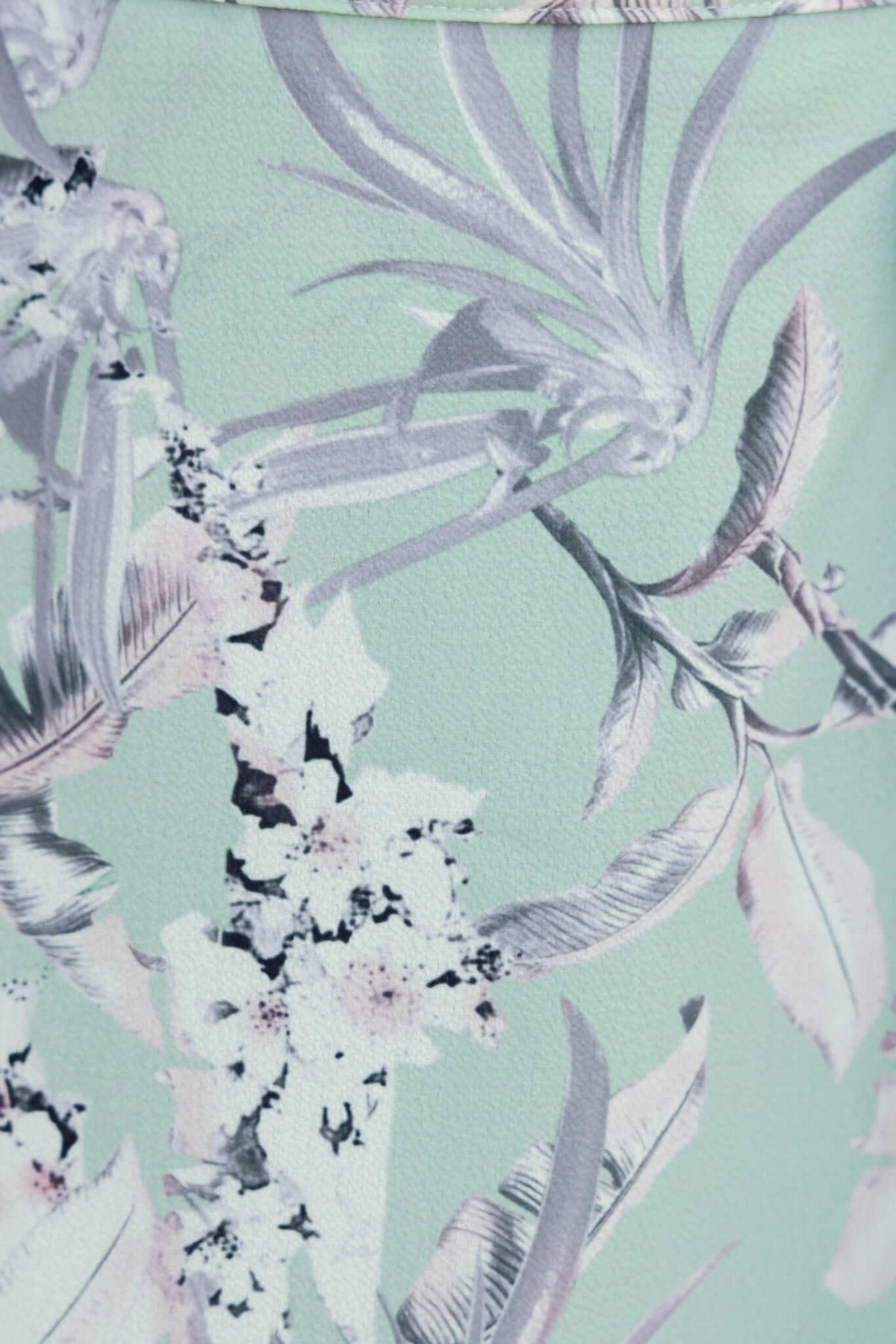 Floral print fabric of Cadern Skirt in mint green, featuring delicate leaves and blooms for a stylish look.