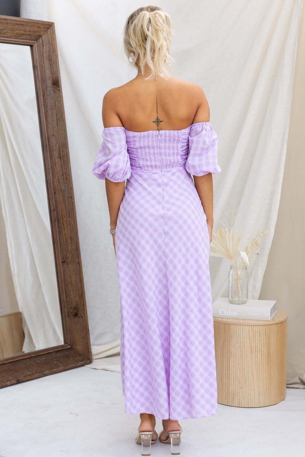 Back view of Elayna Maxi Dress in lavender gingham with puff sleeves and cut-out under bust.