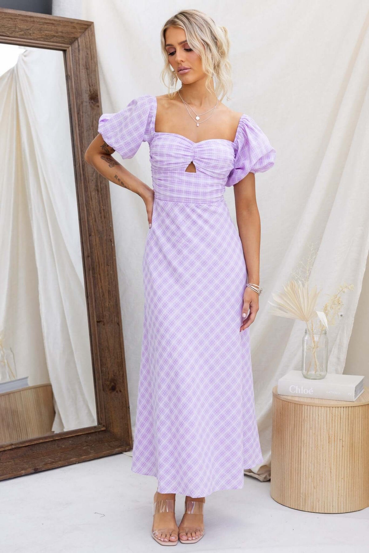 Elayna Maxi Dress in lavender check with cut-out under bust and puff sleeves, styled elegantly for a chic summer look.