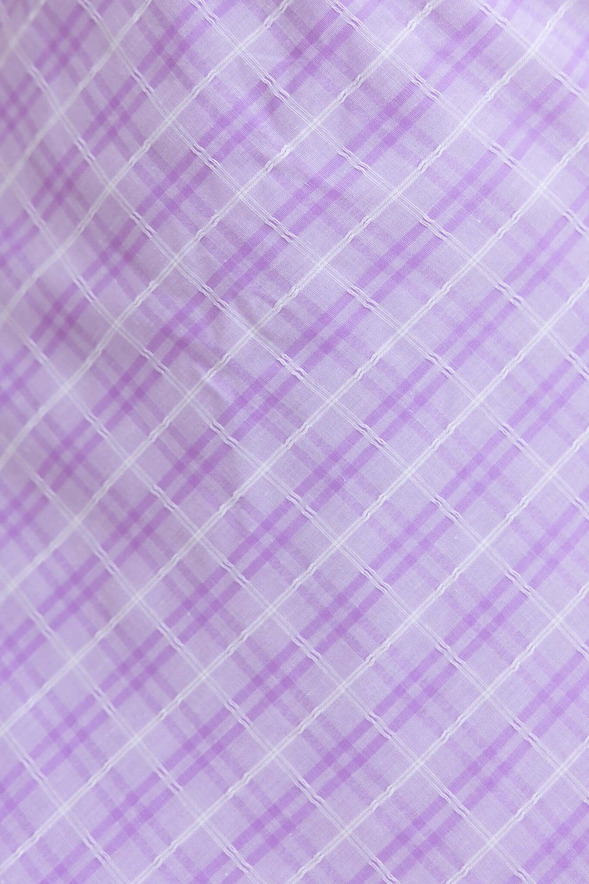 Close-up of lavender and white plaid textile pattern, showcasing delicate lines and soft colors.