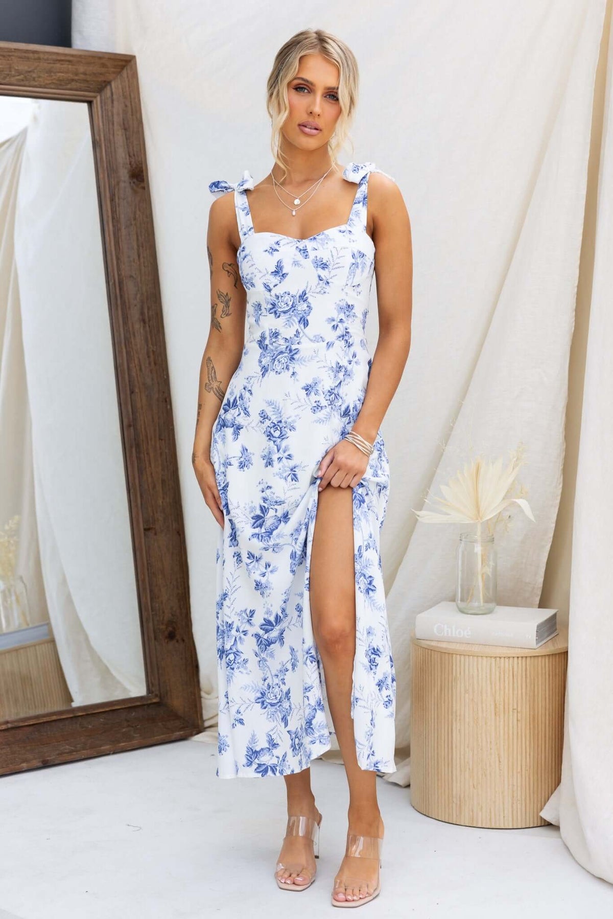 Prescott Midi Dress featuring adjustable tie straps, floral design, front split, and a chic, feminine silhouette.