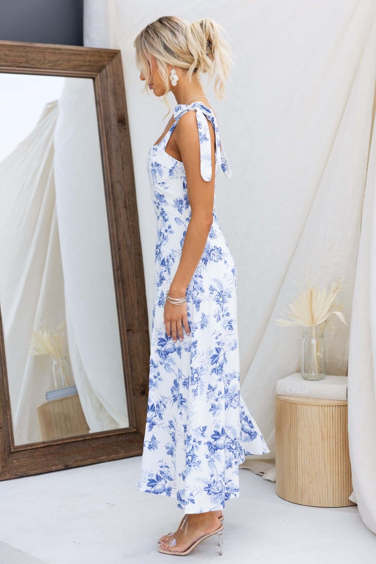 Side view of Prescott Midi Dress featuring floral print, adjustable tie straps, and a split front.