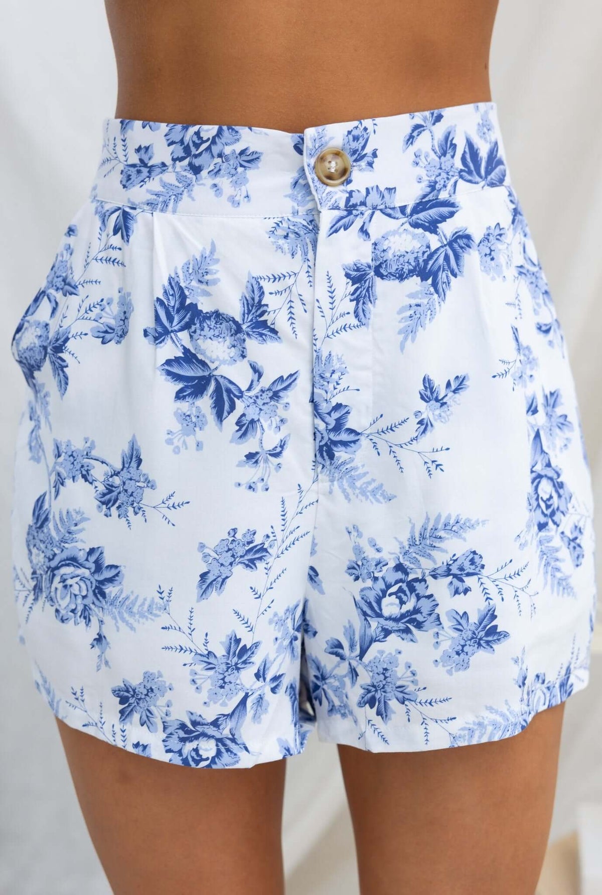 Hadid Shorts featuring floral print, mid-high waist fit, elastic waistband, and pockets, perfect for summer style.