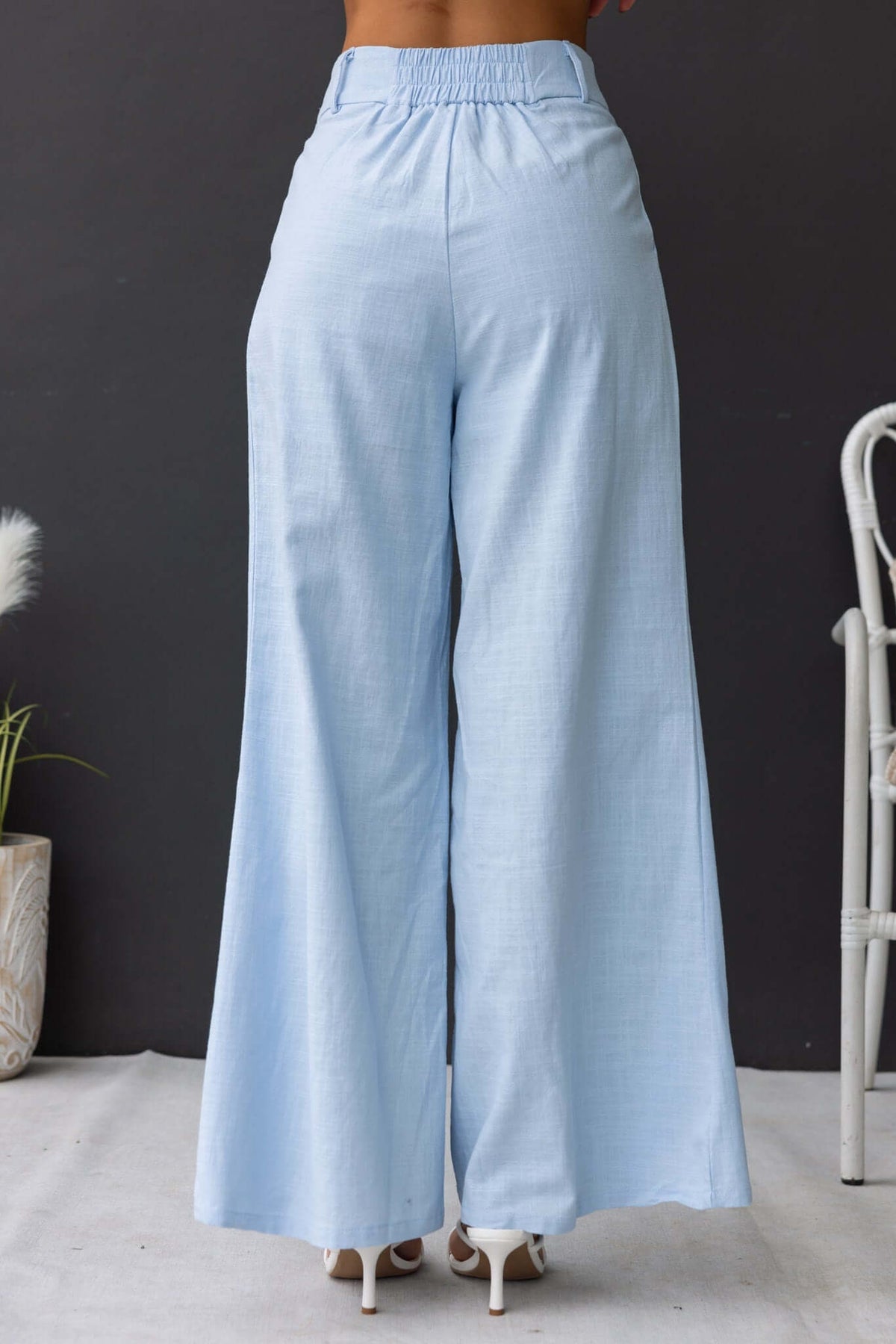 Light blue Socorro Pants featuring a mid-high waist, elastic back, and wide-leg design, ideal for casual wear.