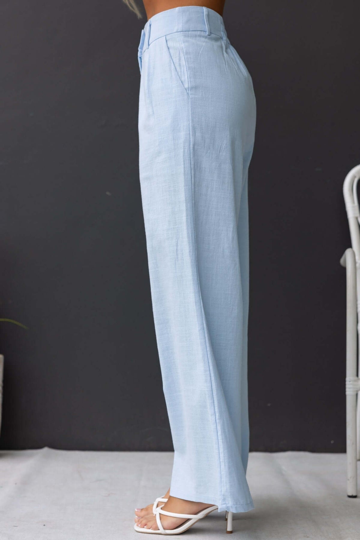 Side view of Socorro Pants in light blue, featuring a mid-high waist, elastic waistband, and a relaxed fit.