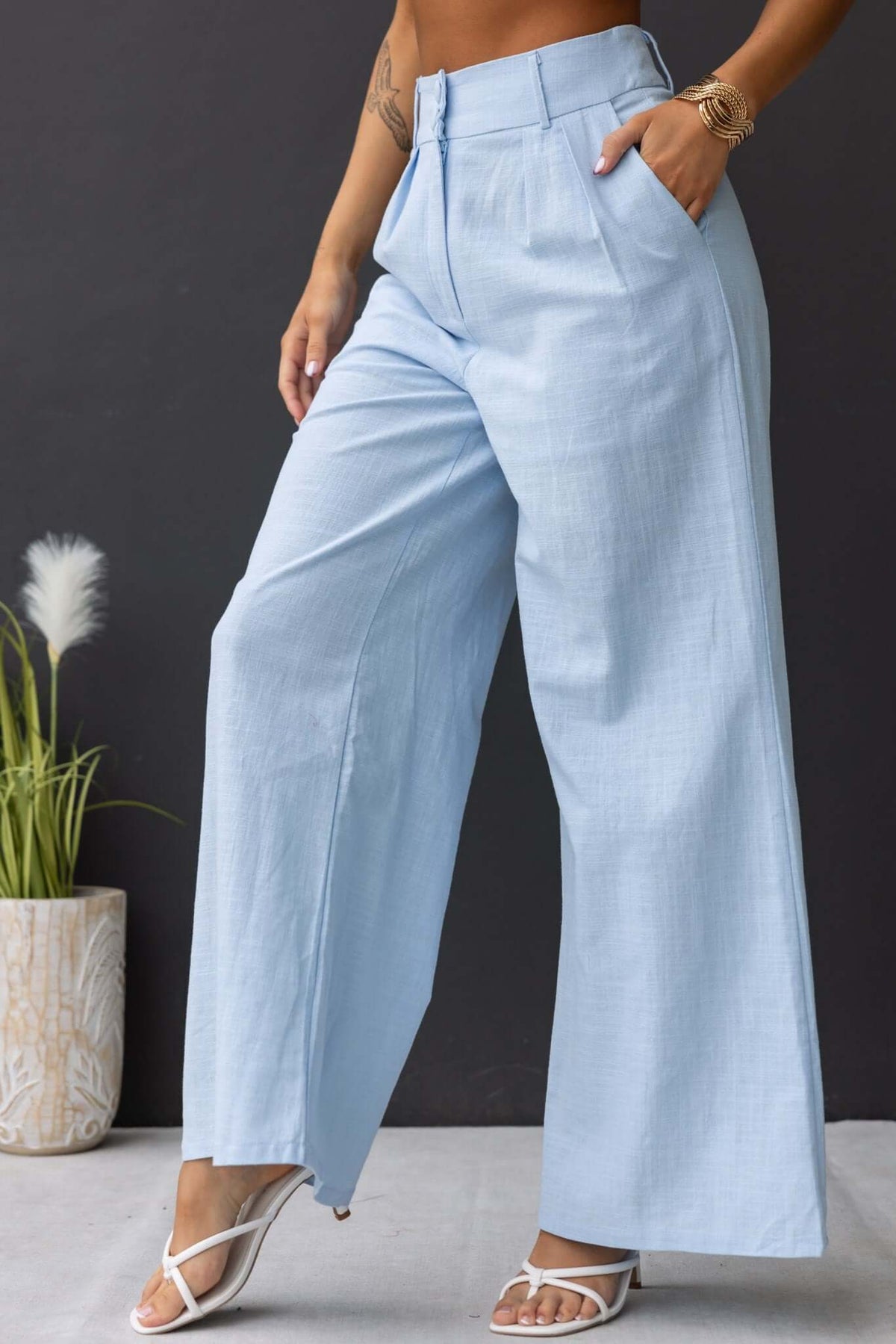 Light blue Socorro Pants with mid-high waist, side pockets, and a stylish wide-leg cut for a fashionable look.