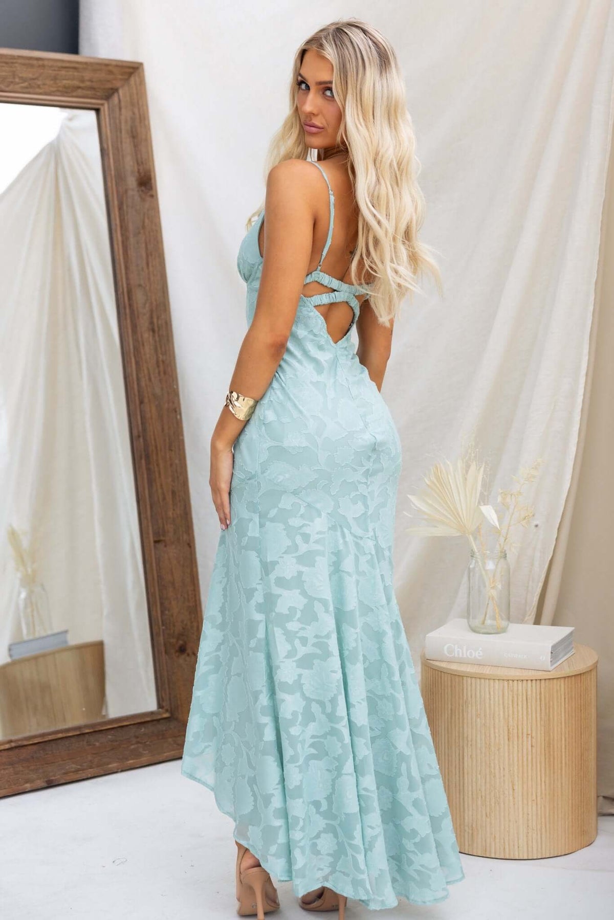 Light blue Fontana Maxi Dress with adjustable straps and high-low hem, showcased on a model from the back.