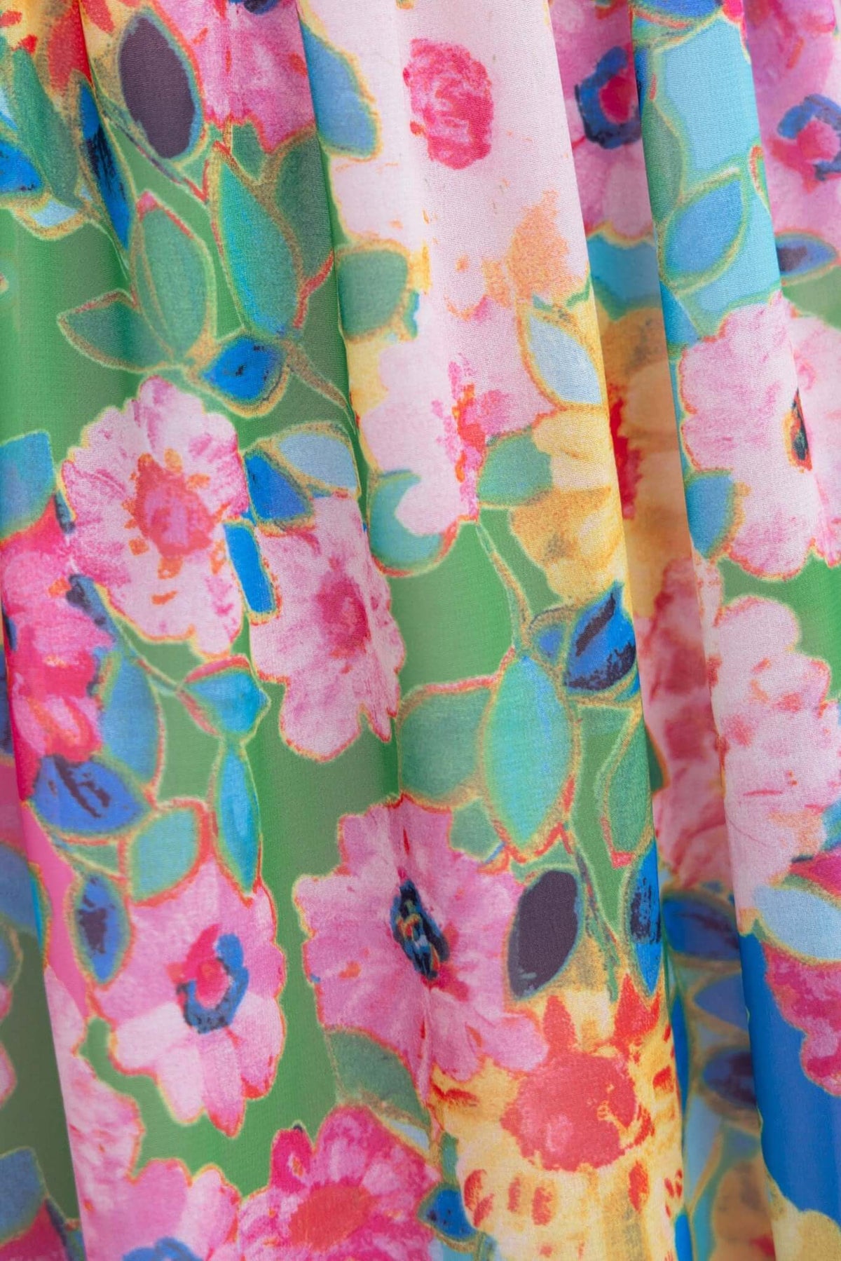 Vibrant floral fabric featuring pink and yellow flowers on a green background, perfect for a maxi dress.