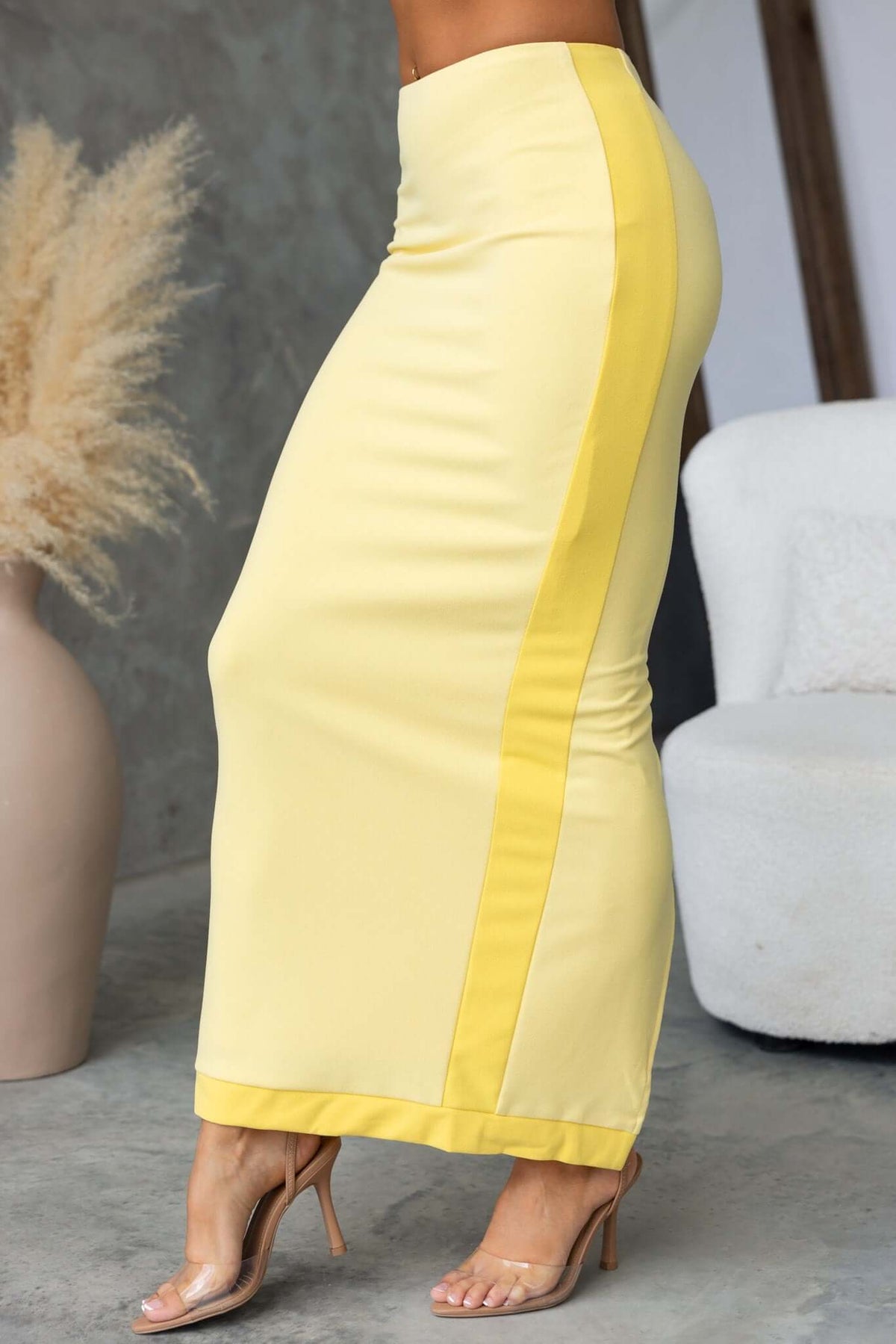 Rianna Maxi Skirt in yellow, mid-high waist with a split back, featuring a stretchy polyester and spandex blend.