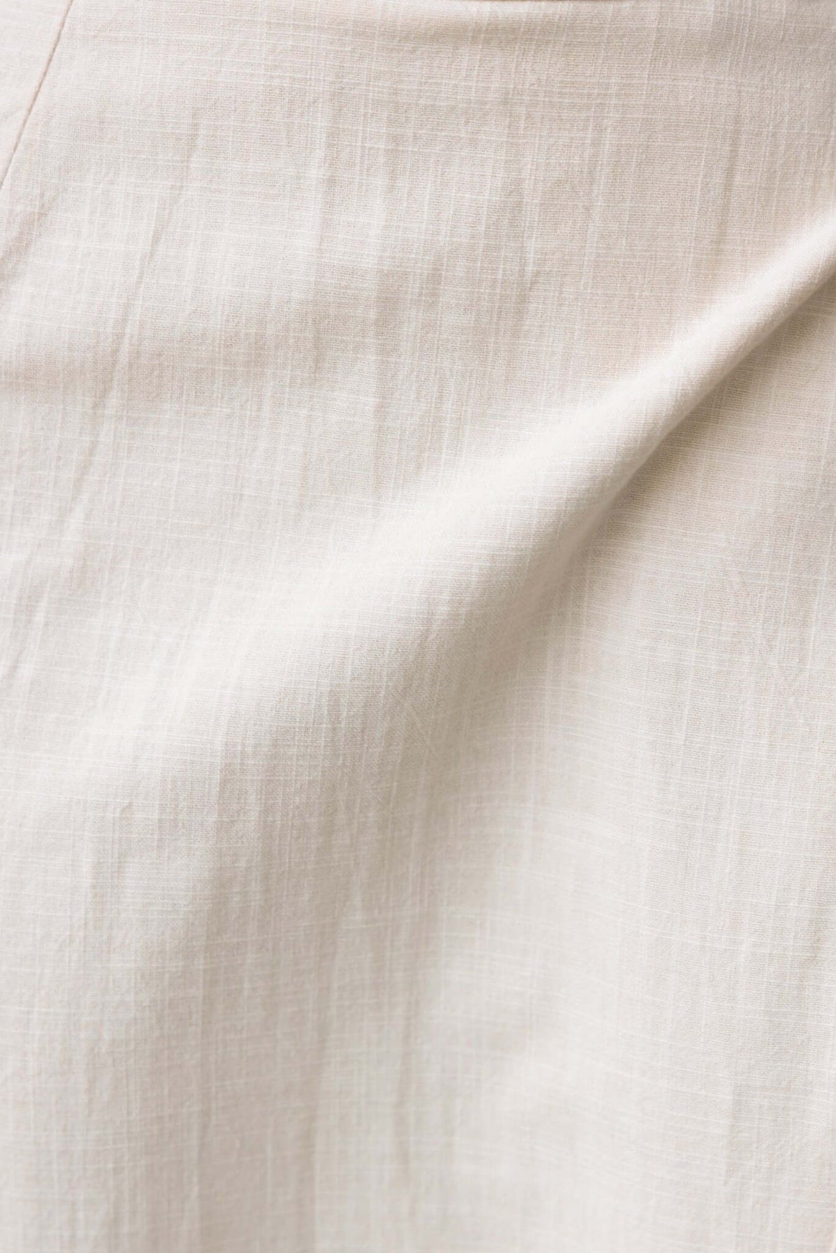Close-up of the soft, textured fabric of the Ferris Maxi Skirt, showcasing its cotton-like feel and natural color.