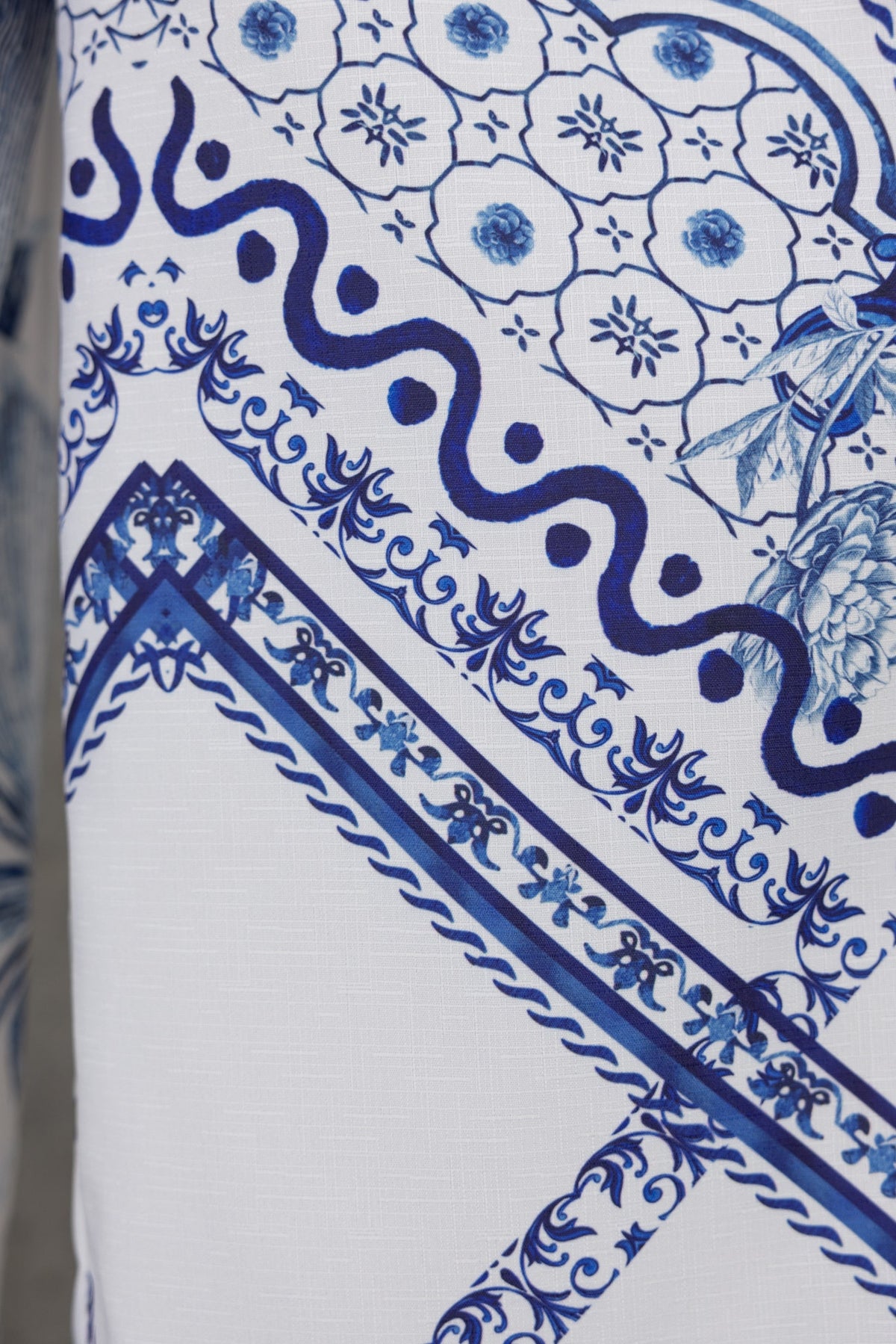 Close-up of abstract blue and white patterned fabric, showcasing intricate designs and textures.