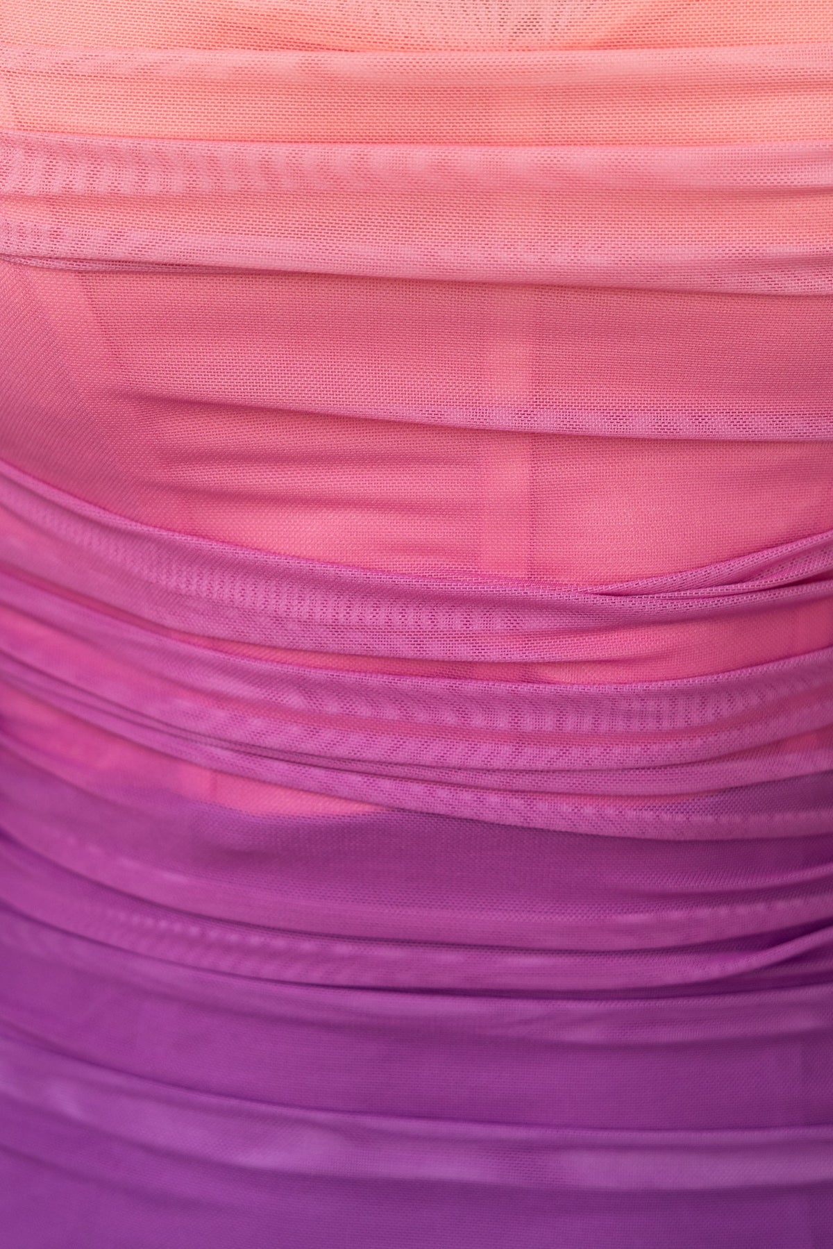 Close-up of Heavy Heart Midi Dress showcasing vibrant ombre ruching in shades of pink and purple.